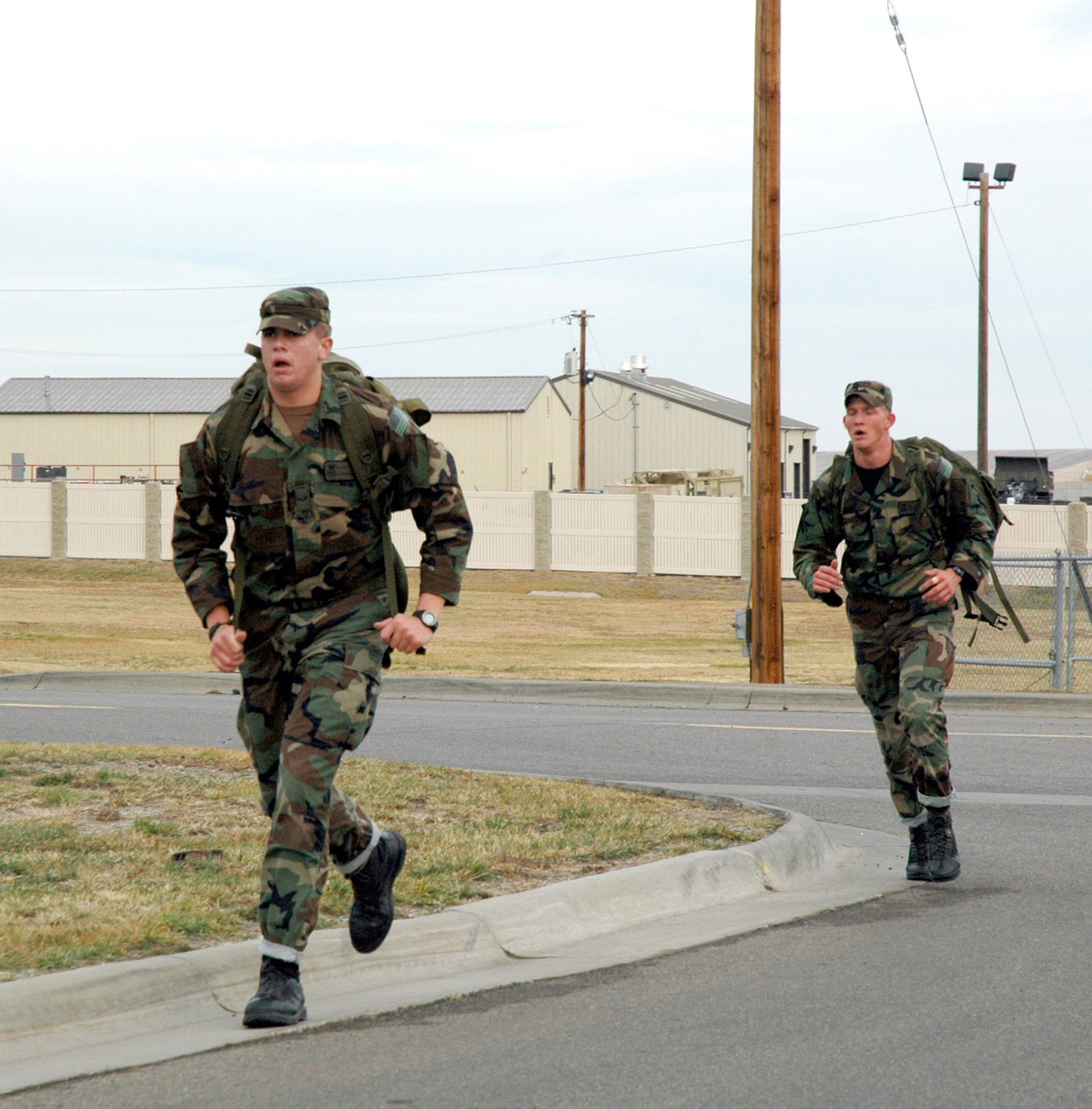 Airmen 1st Class Kris Campbell and Ryan Krastins, both from the 341st Security Forces Group tactical response force, participate in the "Remembrance Ruck" Nov. 9 at Malmstrom Air Force Base, Mont. Thirty-nine security forces members marched four miles with 30 pound backpacks, or "rucksacks" in tribute to the veterans who served their country in the armed services. (U.S. Air Force photo/Senior Airman Eydie Sakura)