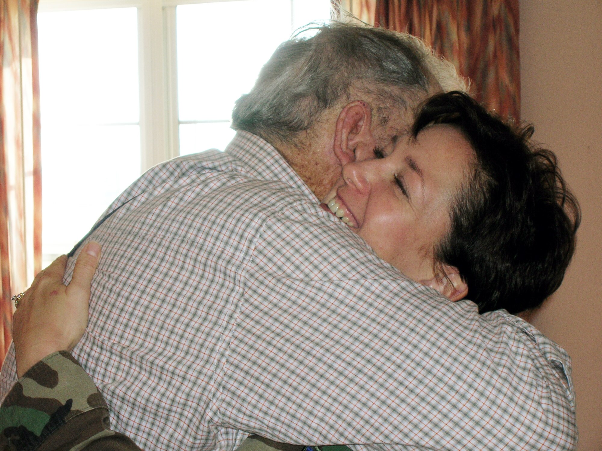 ABILENE, Texas -- Tech. Sgt. Genevieve Sills, secretary of Dyess' 56 Club, hugs Robert B., a resident of the Layman Sanchez Veteran's Home, Nov. 10. She and other members of the club visited local veterans in recognition of Veteran's Day. This event was one of many community outreach programs the 56 Club organizes throughout the year to promote leadership and service. (Courtesy photo)