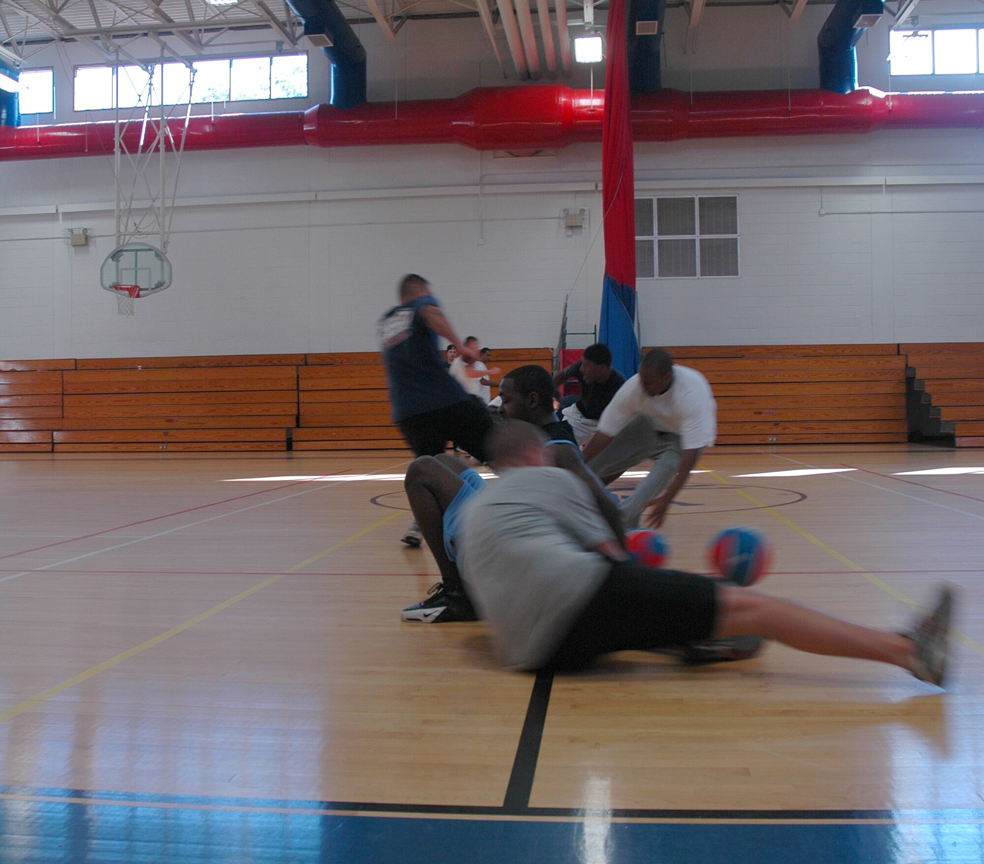 EGLIN AIR FORCE BASE, Fla. -- Members of the 96th Communications Squadron here race to pick up dodgeballs during a squadron dodgeball tournament Nov. 9 at the Eglin Main Fitness Center in recognition of Wingman Day 2007. The Wingman Day 2007 concept emphasizes face-to-face team building, communication and interaction between Airmen. (Photo by Staff Sgt. LuCelia Ball)