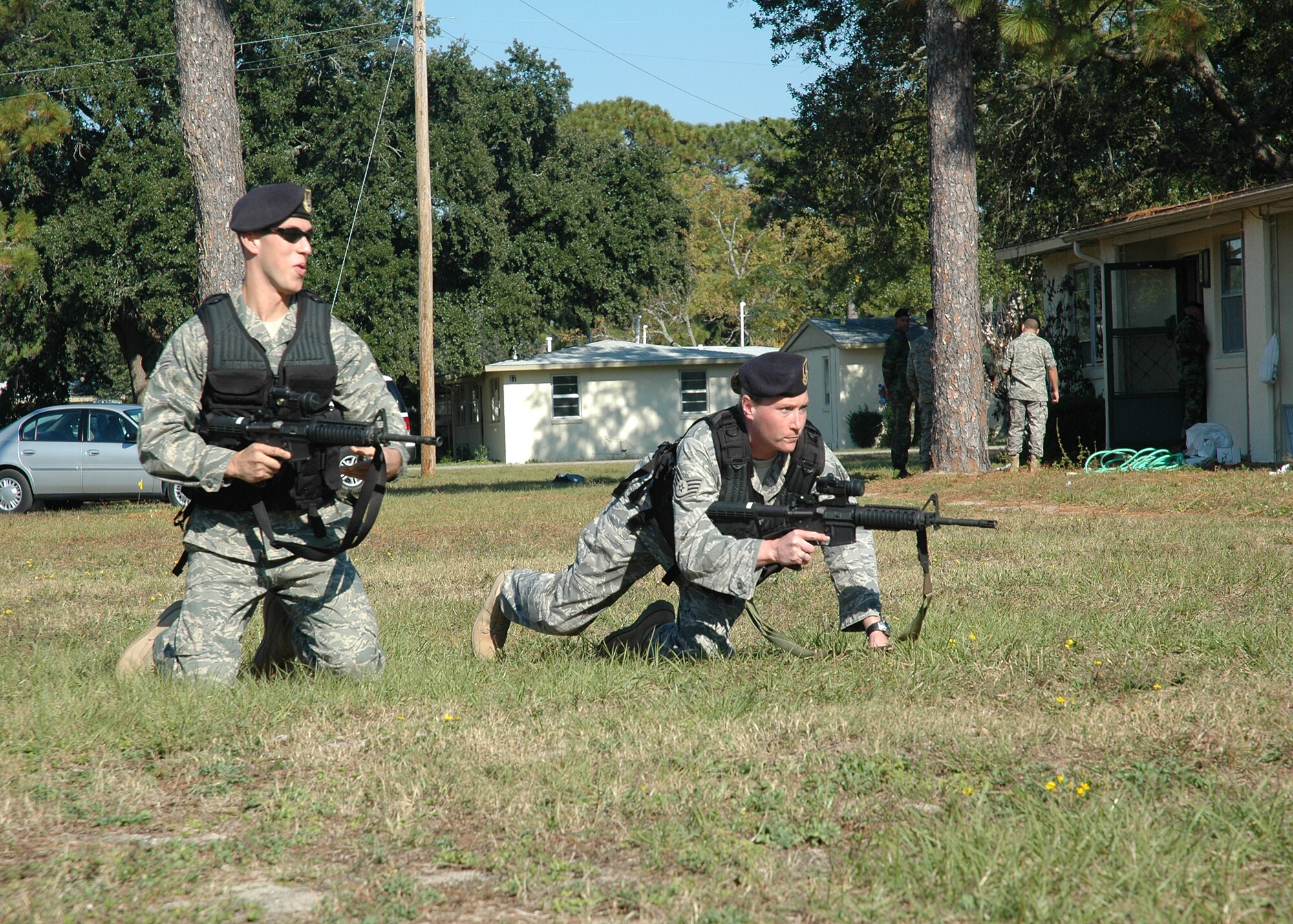 EGLIN AIR FORCE BASE, Fla. -- Airman 1st Class James Baker, left, and Staff Sgt. Michele Stringert, both from the 96th Security Forces Squadron here, use the "bounding" method to approach a building during active shooter training Nov. 9 as part of Wingman Day 2007. About 30 security forces Airmen learned formation, tactics and entry procedures during the training. The Wingman Day 2007 concept emphasizes face-to-face team building, communication and interaction between Airmen. (Photo by Staff Sgt. LuCelia Ball)
