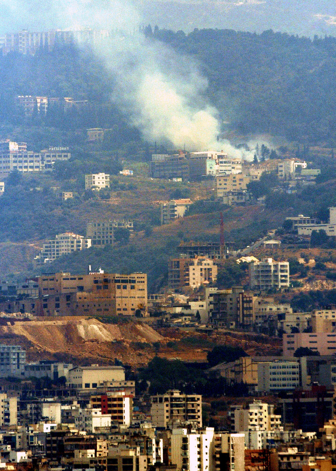 White smoke rises from a hillside following an Israeli air force strike July 22, 2006, in Beirut, Lebanon. A new study of last year's Israel-Hezbollah War, published by Air University Press, examines the role of airpower in fighting terrorist organizations and is part of a larger effort to develop strategic thinking in the Air Force. (U.S. Navy photo/Petty Officer 1st Class Robert J. Fluegel) 

