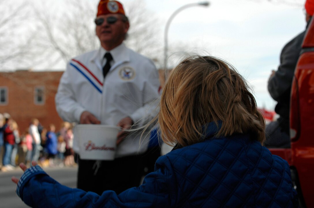 A young spectator waves for candy during a parade in downtown Rapid City, S.D., Nov. 11, 2007.  Rapid City hosted this parade down Main Street in honor of all those who have served and are currently serving in the United States armed forces on Veterans Day.  (U.S. Air Force photo by SSgt Michael B. Keller)(Released)