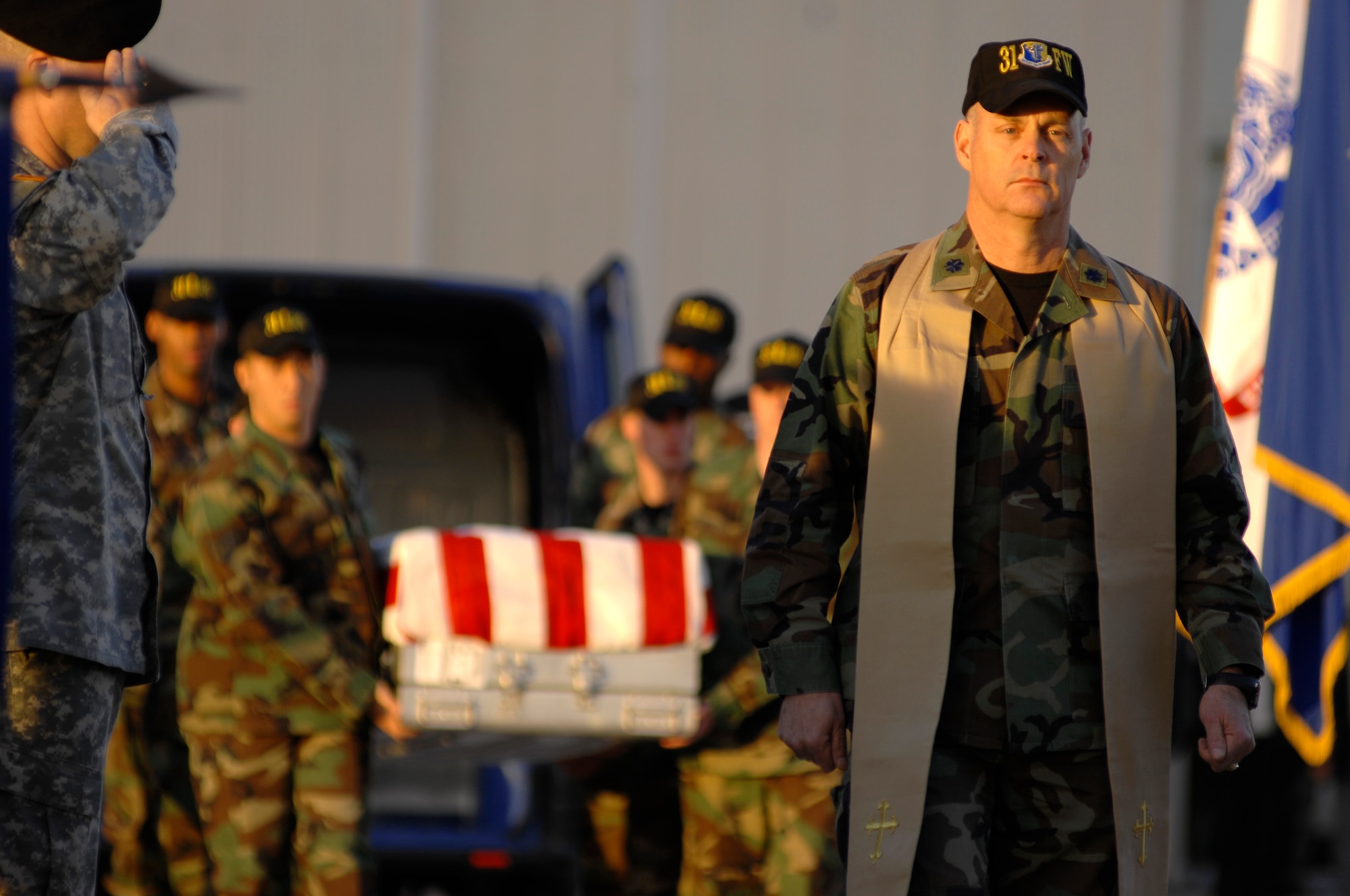 AVIANO AIR BASE, Italy--Chaplain (Lt. Col.) Jimmy Browning from the  31st Fighter Wing leads a fallen Airman onto a C-130 during a repatriation ceremony Nov. 13 for six servicemembers who were killed when a U.S. Army UH-60 Black Hawk helicopter attached to the 1st Battalion, 214th Aviation Regiment crashed Nov. 8, 22 miles southwest of Aviano.  (U.S. Air Force photo/Airman 1st Class Ashley Wood) 