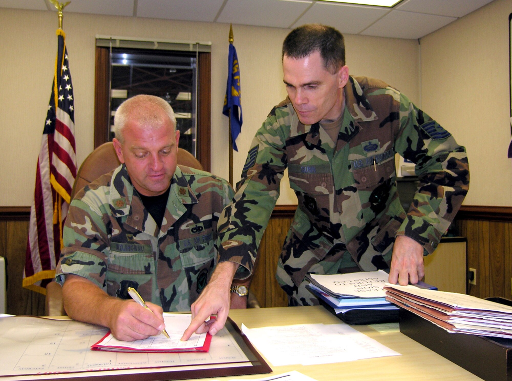 SEYMOUR JOHNSON AIR FORCE BASE, N.C. -- Tech. Sgt. Douglas Gunn, a reservist with the 916th Aircraft Maintenance Squadron, works with his commander,  Maj. Pete Wojihowski. Sgt. Gunn is new to the Reserve refueling wing and works as a personnel craftsman. 