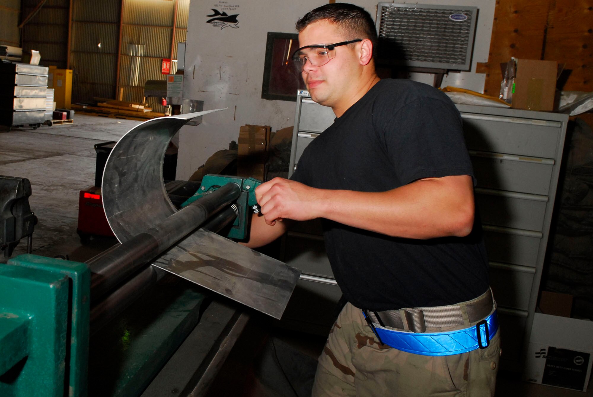 BALAD AIR BASE, Iraq -- Staff Sgt. Adrian Lopez, a 332nd Expeditionary Maintenance Squadron aircraft structural maintainer, uses a metal roller to create a patch for an F-16 Fighting Falcon panel. The sheet fabrication flight creates metal pieces for all active-duty vehicles here, including Army assets. Sergeant Lopez is deployed from Spangdahlem Air Base, Germany.  (U.S. Air Force photo/Staff Sgt. Joshua Garcia)