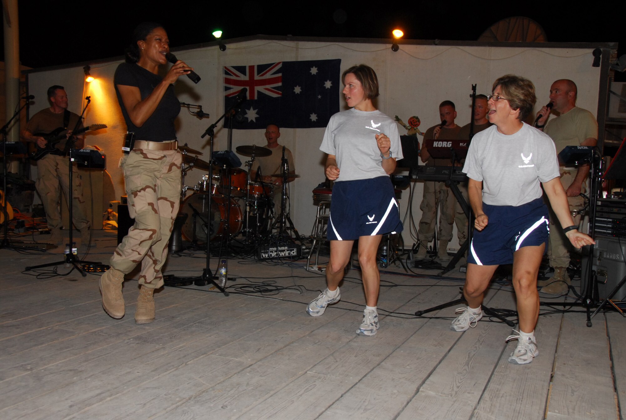 SOUTHWEST ASIA - The US CENTAF band, Live Round, performs for Australian and U.S. forces at the Royal Australian Air Force's 'Thunderbox' Nov. 10 at a base in southwest asia. Live Round is using this southwest asia air base as their home base while they tour throughout the southwest asia theater. Members of the band include Chief Master Sgt. Paul Eschliman, vocals, Senior Master Sgt. Christine Kosky, bass, Master Sgts. Matthew Ascione, guitar, Dennis Hoffman, percussion and drums,  Shani Prewitt, vocals, Tech. Sgts. Michael Mason, vocals, and Jonathan McPherson, keyboards. Master Sgt. Joseph Grasso is the operations manager and Tech. Sgt. Chad Randolph is the audio engineer. (U.S. Air Force photo/Staff Sgt. Douglas Olsen)