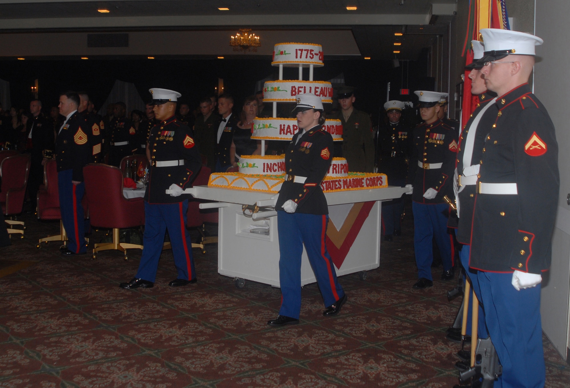 Members of Marine Wing Headquarters Squadron 1 wheel their service's birthday cake to the center of the room during the Marine Ball at the Butler Officer's Club Nov. 8, 2007. The U.S. Marine Corps celebrated its 232nd anniversary Nov. 10. MWHS-1 is the parent organization of Marine Wing Liaison Kadena. MWLK provides comprehensive operational and logistical support to local and deployed U.S. Marine Corps and U.S. Navy squadrons operating at Kadena Air Base, Japan, and facilitates essential liaison with the U.S. Air Force’s 18th Wing and the U.S. navy’s Commander Fleet Activities Okinawa, which are located on Kadena. (U.S. Air Force photo/Master Sgt. Jeff Loftin)