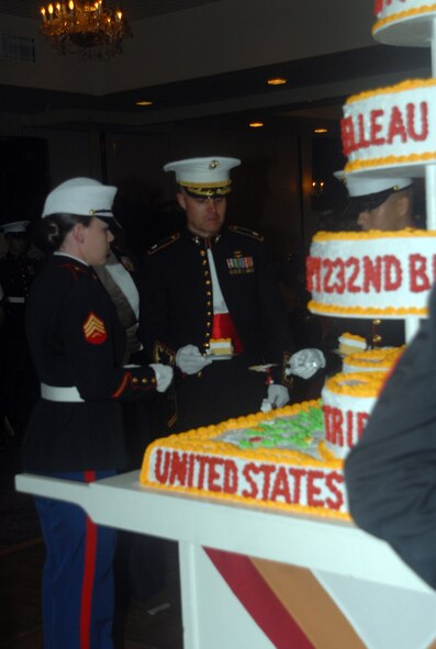 The oldest and youngest members of Marine Wing Headquarters Squadron 1 prepare to eat a piece of their service's birthday cake during the Marine Ball at the Butler Officer's Club Nov. 8, 2007. The U.S. Marine Corps celebrated its 232nd anniversary Nov. 10. MWHS-1 is the parent organization of Marine Wing Liaison Kadena. MWLK provides comprehensive operational and logistical support to local and deployed U.S. Marine Corps and U.S. Navy squadrons operating at Kadena Air Base, Japan, and facilitates essential liaison with the U.S. Air Force’s 18th Wing and the U.S. navy’s Commander Fleet Activities Okinawa, which are located on Kadena. (U.S. Air Force photo/Master Sgt. Jeff Loftin)