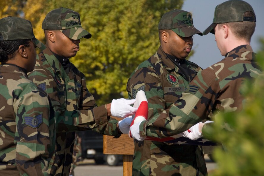 KUNSAN AIR BASE, South Korea--  Members of the 8th Fighter Wing Honor Guard fold the U.S. flag during a Veterans Day ceremony here Nov. 12.  (U.S. Air Force Photo/Master Sgt. Jack Braden)