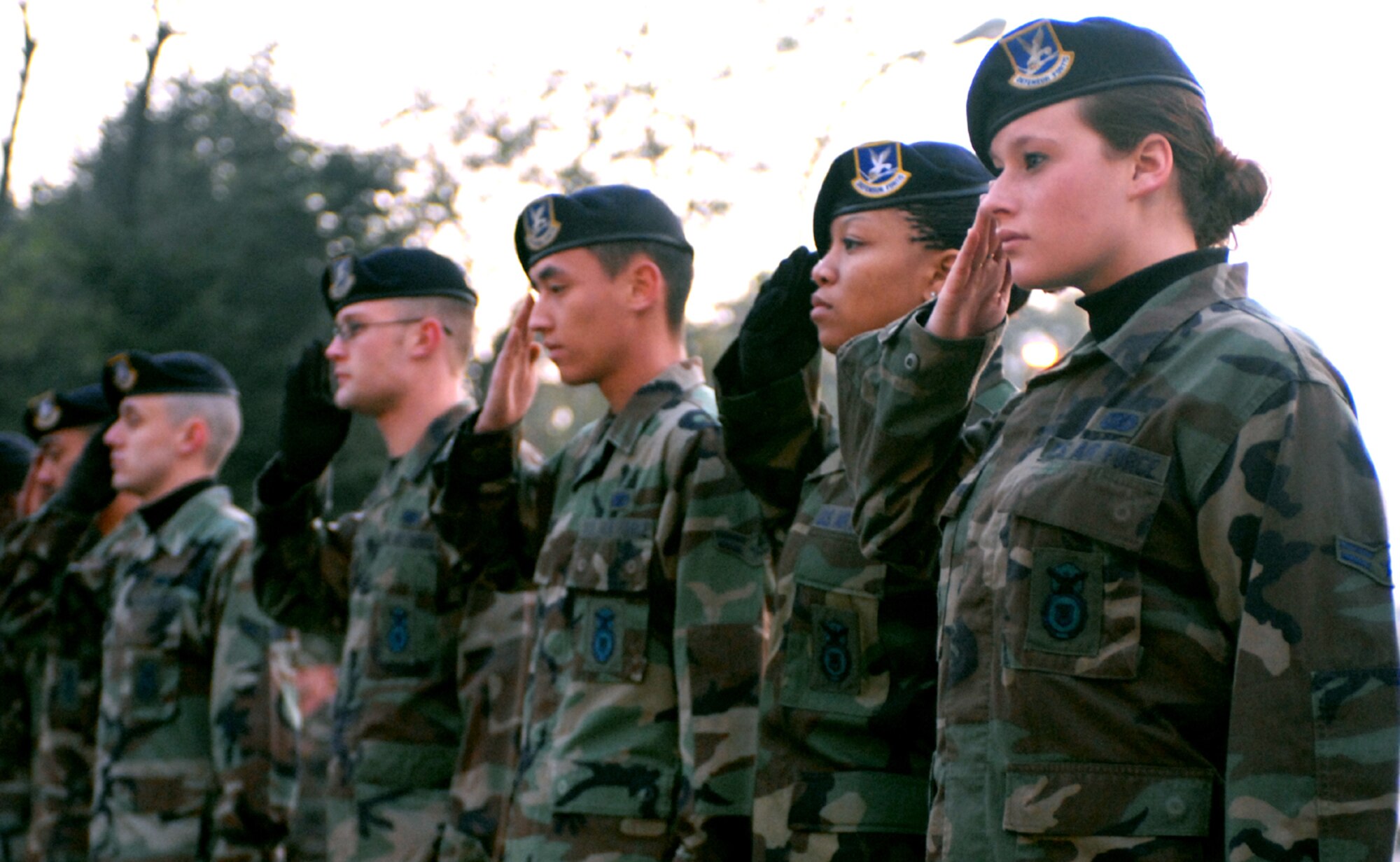 OSAN AIR BASE, Republic of Korea --  Airman 1st Class Jessica Dietz and other members of the 51st Security Forces Squadron salute veterans past, present and future in a special Veterans Day flag-raising ceremony the morning of Nov. 12. Veterans Day commemorates the signing of the armistice that ended hostilities in World War I. (U.S. Air Force photo by 1st Lt. John Ross)