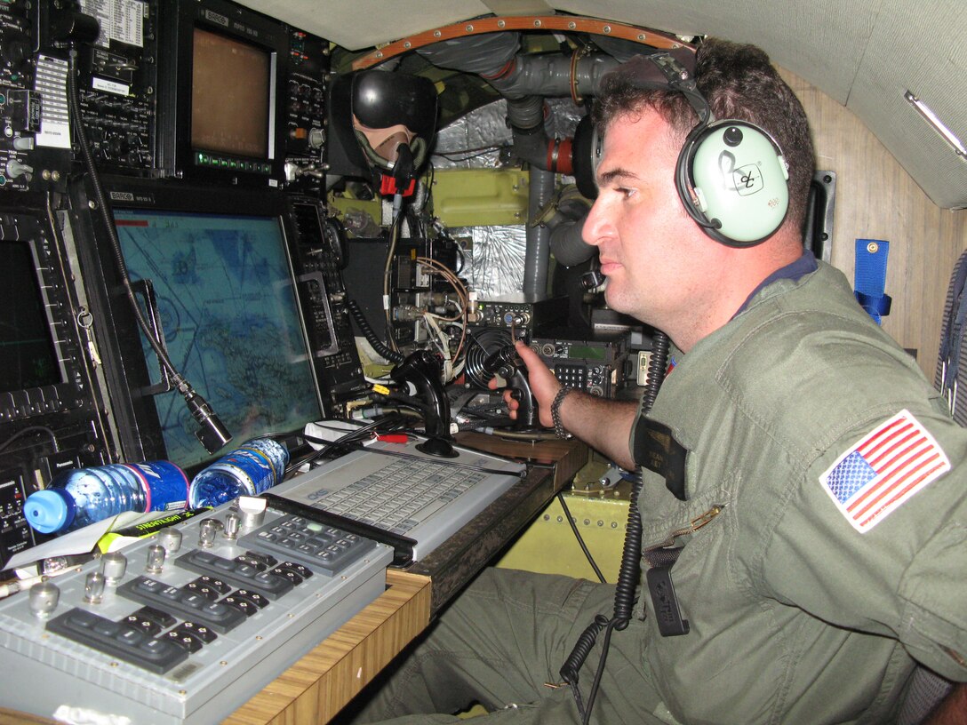 Coast Guard Petty Officer 2nd Class Sean Benners trains his eyes on a console in the rear of a HU-25 “Falcon” aircraft that includes a radar system, infrared camera and nautical map to evaluate boat traffic below. Photo by Donna Miles

