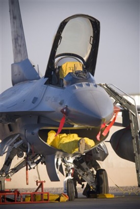 U.S. Air Force Senior Airman Edwin Widgeon crawls into the intake of an F-16 Fighting Falcon aircraft to check for foreign objects prior to an engine test at Balad Air Base, Iraq, on Nov. 9, 2007. Widgeon is deployed to Iraq as part of the 332nd Expeditionary Aircraft Maintenance Squadron from the New Mexico Air National Guard's 150th Fighter Wing.  