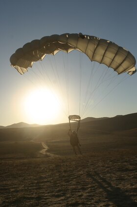 A Marine from U.S. Marine Corps Forces, Special Operations Command's 1st Marine Special Operations Battalion, touches down after a 10,000 foot free-fall jump at Basilone Drop Zone here Nov. 14. Marines conducted static-line and free-fall jumps during the day and night in order to hone their parachute insertion skills.
