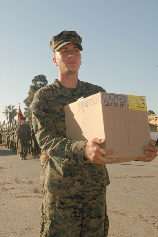 Pvt. Joshua McCain, Platoon 2131, Company F, collects the personal effects he brought with him to the depot 13-weeks ago when be arrived for basic training.