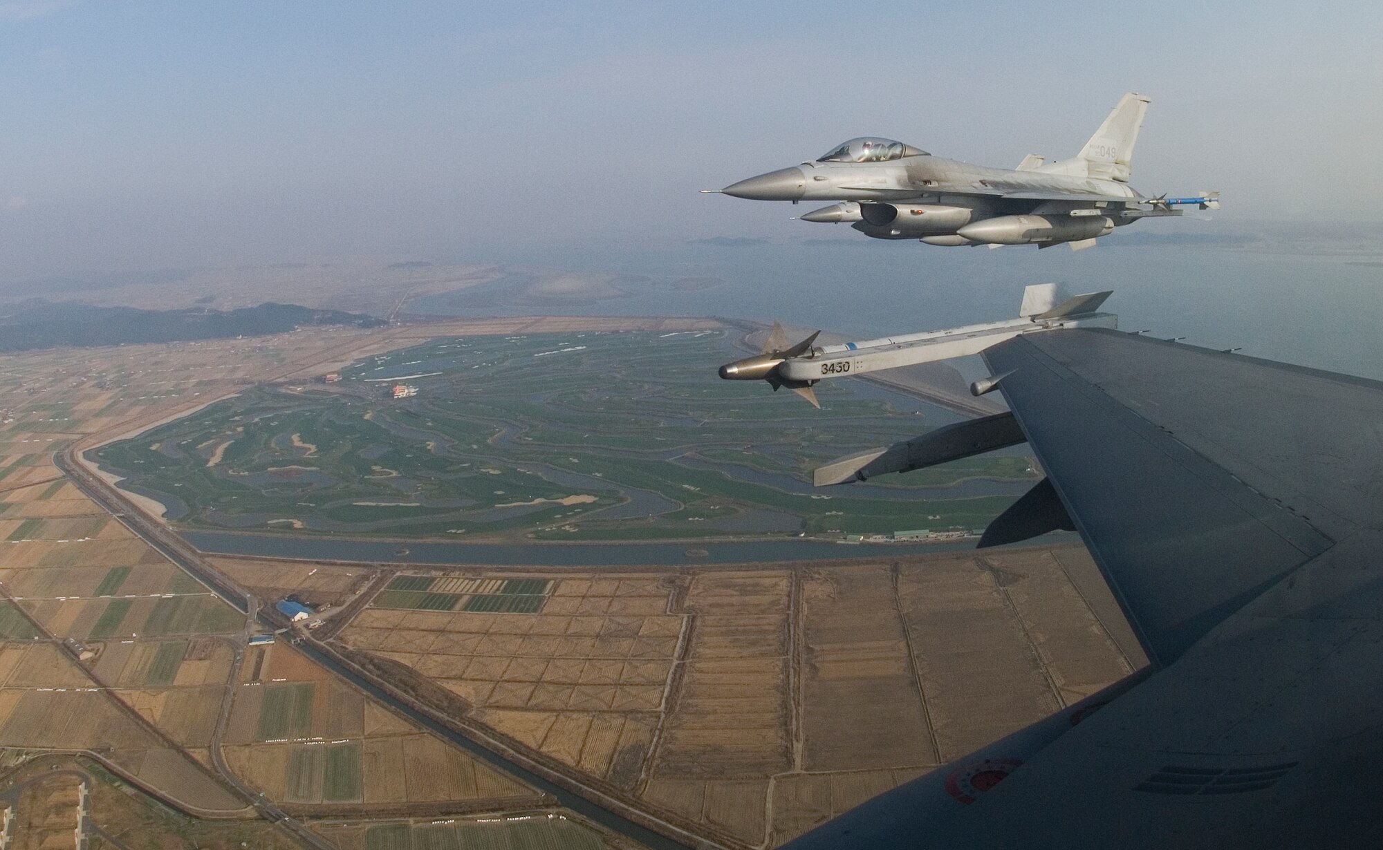 KUNSAN AIR BASE, South Korea--  Two F-16s from the Republic of Korea Air Force’s (ROKAF) 111th Fighter Squadron, form up on Kunsan jets after completing a joint training mission with pilots from the 8th Fighter Wing here Nov. 14. ROKAF pilots joined with Kunsan pilots during the joint mission to give pilots from both countries a chance to work together and hone their war-fighting skills.  (U.S. Air Force Photo/Master Sgt Jack Braden) 