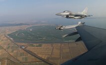 KUNSAN AIR BASE, South Korea--  Two F-16s from the Republic of Korea Air Force’s (ROKAF) 111th Fighter Squadron, form up on Kunsan jets after completing a joint training mission with pilots from the 8th Fighter Wing here Nov. 14. ROKAF pilots joined with Kunsan pilots during the joint mission to give pilots from both countries a chance to work together and hone their war-fighting skills.  (U.S. Air Force Photo/Master Sgt Jack Braden) 