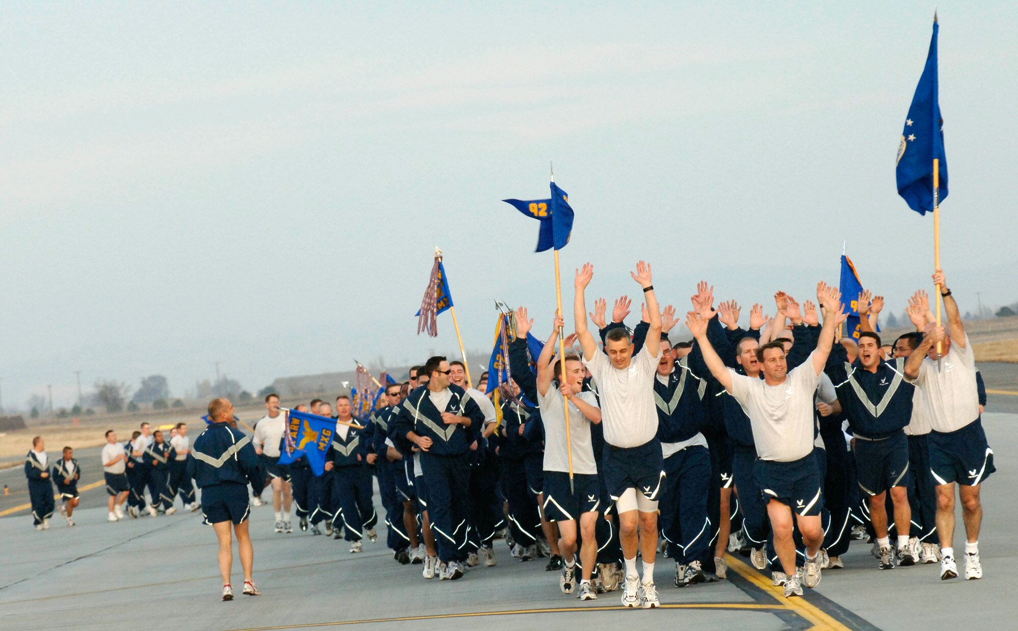 FAIRCHILD AIR FORCE BASE, Wash. – Col. Thomas J. Sharpy, 92nd Air Refueling Wing commander, and Col. Roger Watkins, 92nd ARW vice commander, rally members of Team Fairchild with a battlefield shout as Chief Master Sgt. Daniel McMullan, 92nd Operations Group superintendent, raises the guidon during the Wingman Day run on Nov. 9. (U.S. Air Force photo / Staff Sergeant JT May III)