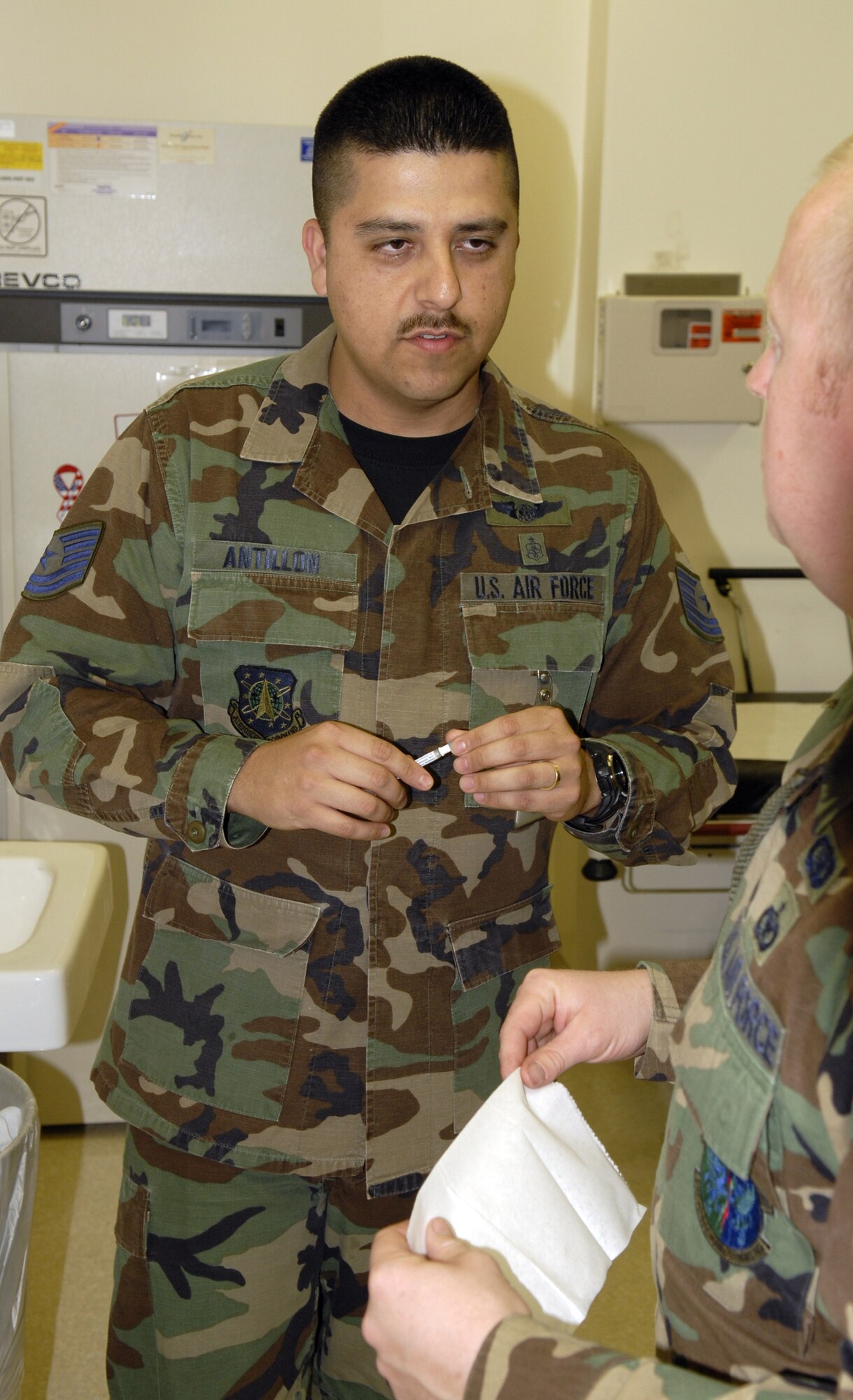 VANDENBERG AIR FORCE BASE, Calif. -- Tech. Sgt. Jesus Antillon gives preparation instructions before he gives the intranasal influenza vaccine to a patient at the immunization clinic on Nov. 13.  The 30th Medical Group pediatrics NCOIC gives the vaccine as an annual requirement for all active duty members to combat the potential of catching the influenza virus. (U.S. Air Force photo/Airman 1st Class Adam Guy)