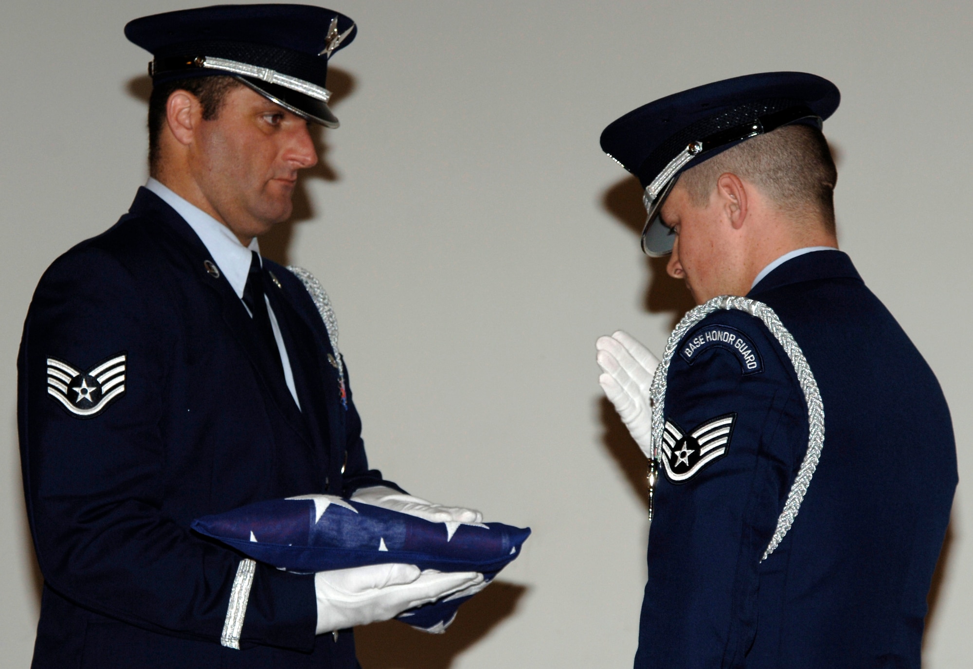 MCCONNELL AIR FORCE BASE, Kan. -- Staff Sgt. John Herrman, left, and Staff Sgt. John Baxter, Kansas Air National Guard honor guard, retire the flag during the Kansas Masonic Home’s Veterans Day Luncheon Nov. 12.  (Photo by Airman 1st Class Laura Suttles)