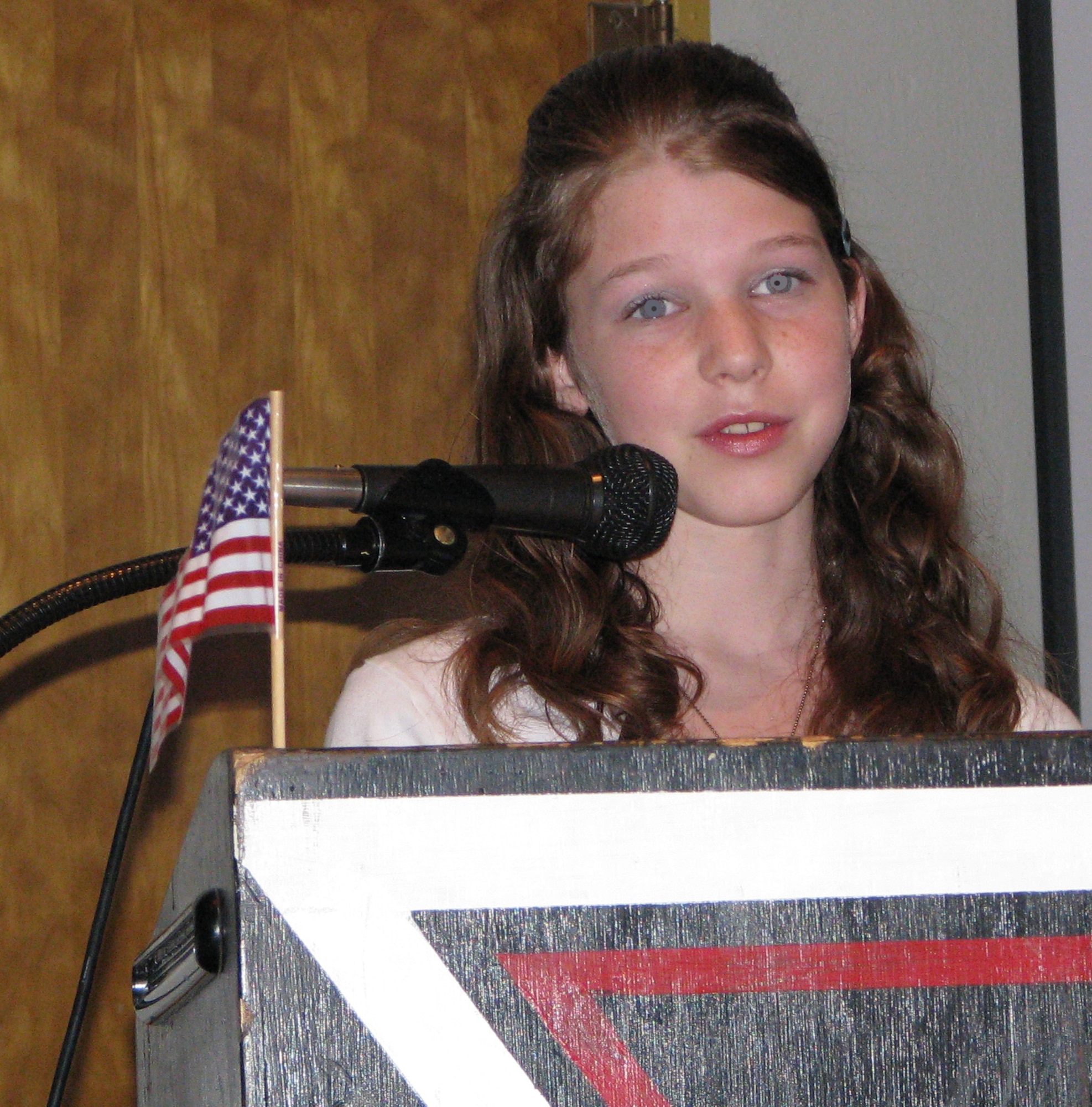 MCCONNELL AIR FORCE BASE, Kan. -- Felicia Jarvis, daughter of Tech. Sgt. Chad Jarvis, 22nd Maintenance Squadron, a 7th grader at Derby Middle School delivers a speech Nov. 7 to Veterans during a ceremony celebrating Veterans Day.  The speech was given on behalf of the Derby Middle School student body.  (Photo by Marissa Hildebrand, courtesy of Derby Middle School)