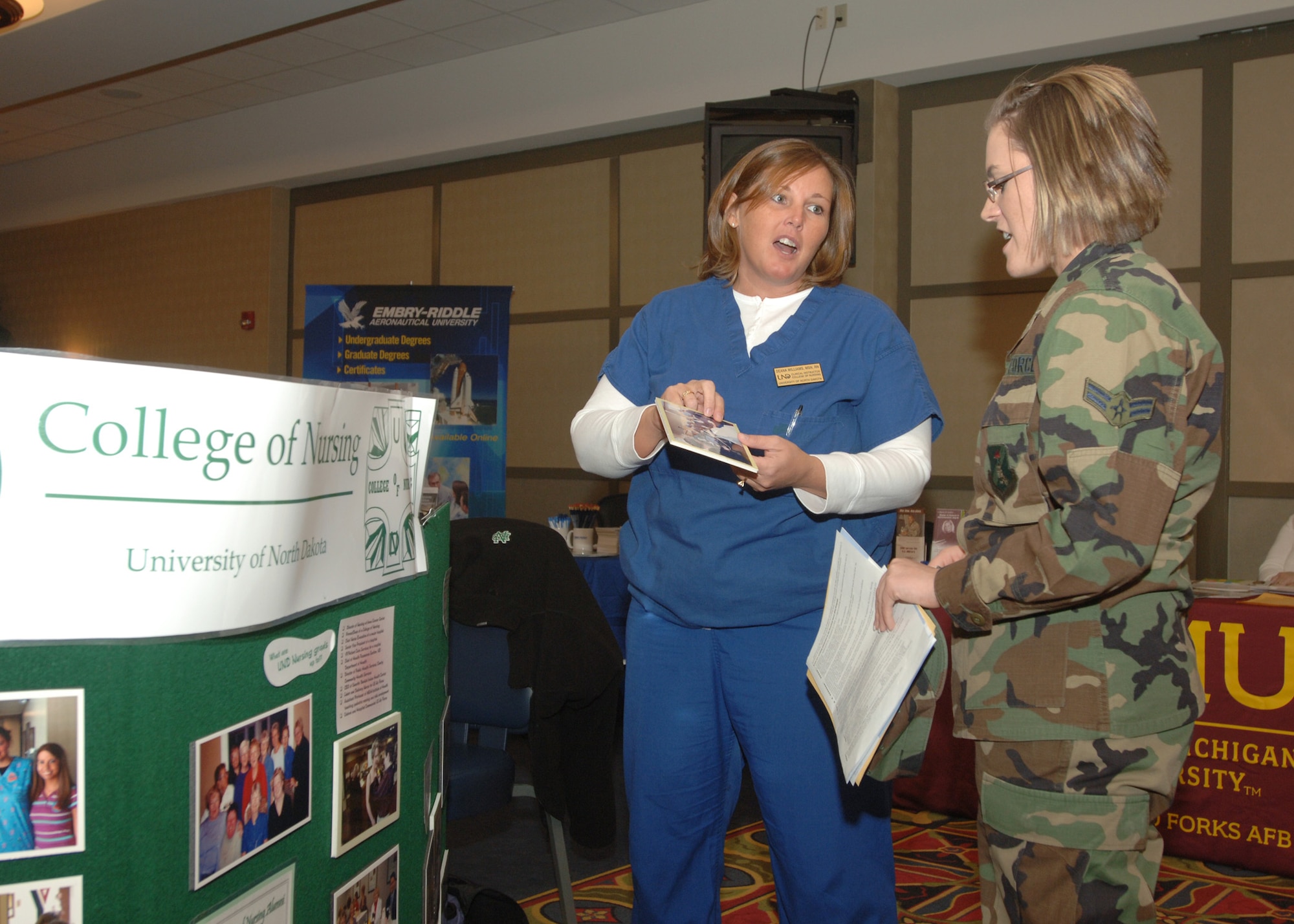 Airman 1st Class Sara Strand listens to Deana Williams, University of North Dakota College of Nursing, about nursing degrees and opportunities to commission at the Education and Training Fair on Grand Forks Air Force Base, North Dakota on November 15, 2007. Several colleges and institutes showed up in full force at the fair to provide Airmen and their families with potential career and education opportunities that they may not have been aware of. (U.S. Air Force photo/Senior Airman Chad M. Kellum)