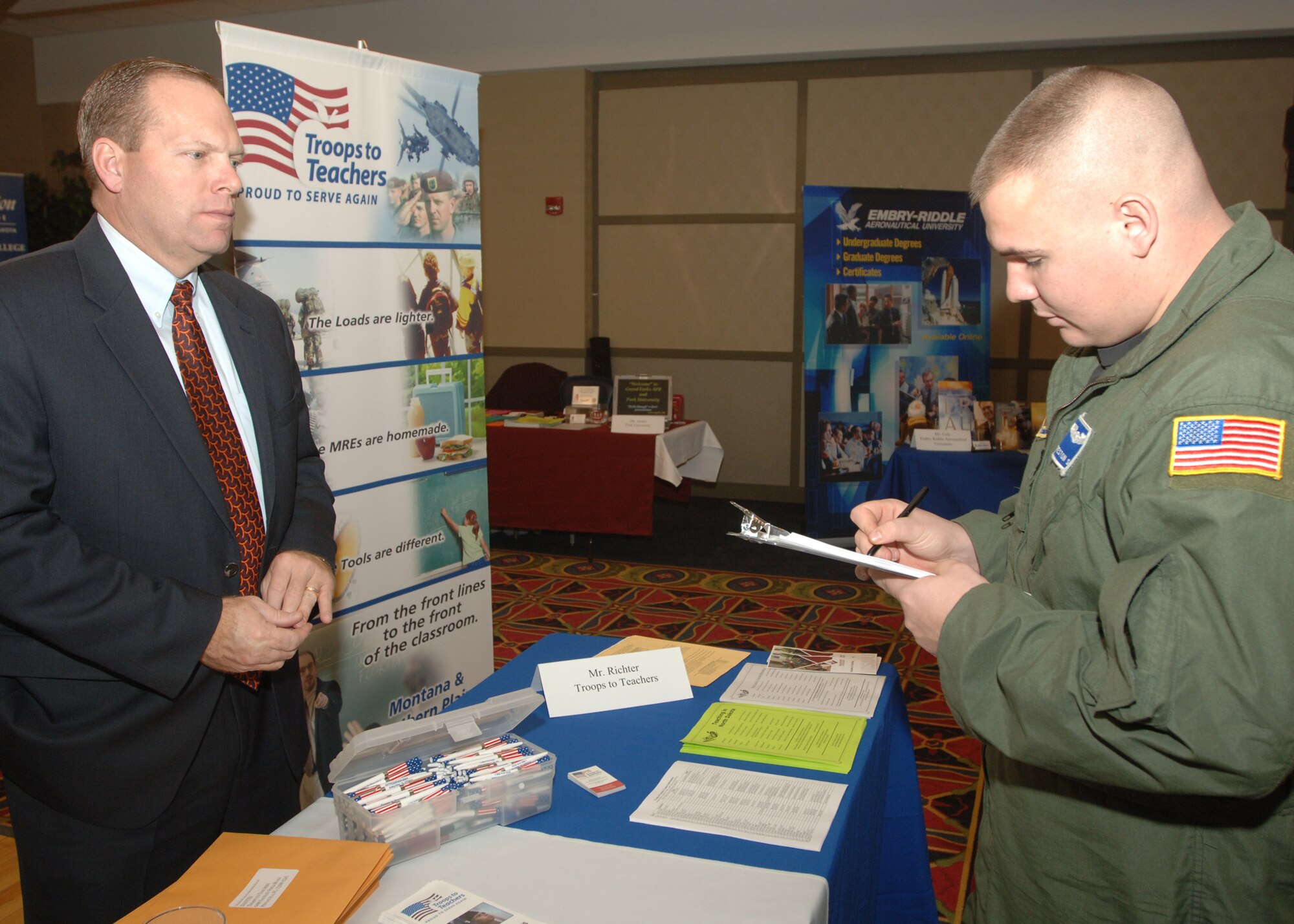 Staff Sergeant Creston Saul, 912th Air Refueling Squadron, signs up to receive more information about the Troops to Teachers programs at the Education and Training Fair here Nov. 15. Several colleges and institutes showed up in full force at the fair to provide Airmen and their families with potential career and education opportunities that they may not have been aware of. (U.S. Air Force photo/Senior Airman Chad M. Kellum)