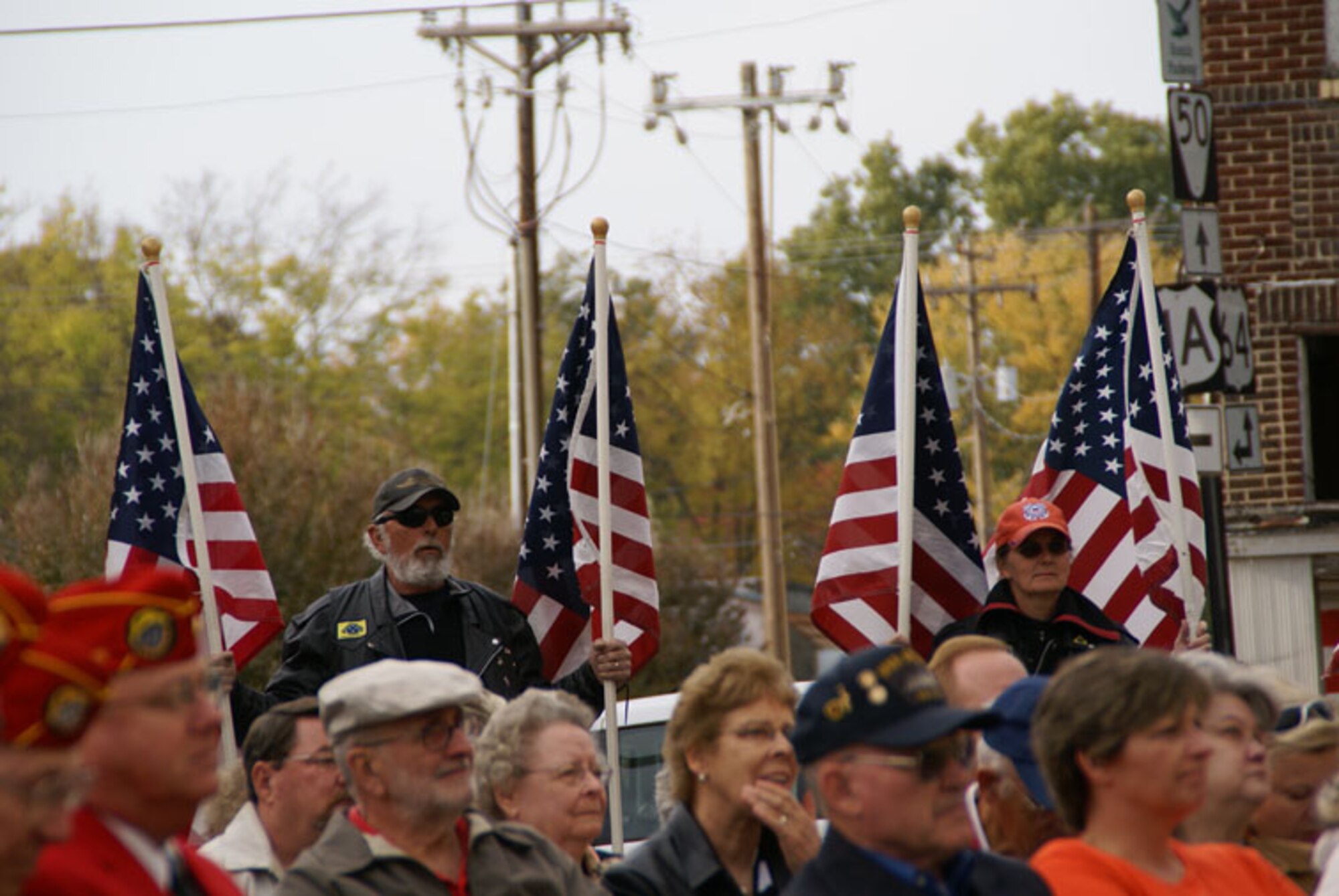 A Patriot Guard rider proudly displays the American Flag during the ceremony. (Photo by Philip Lorenz III)