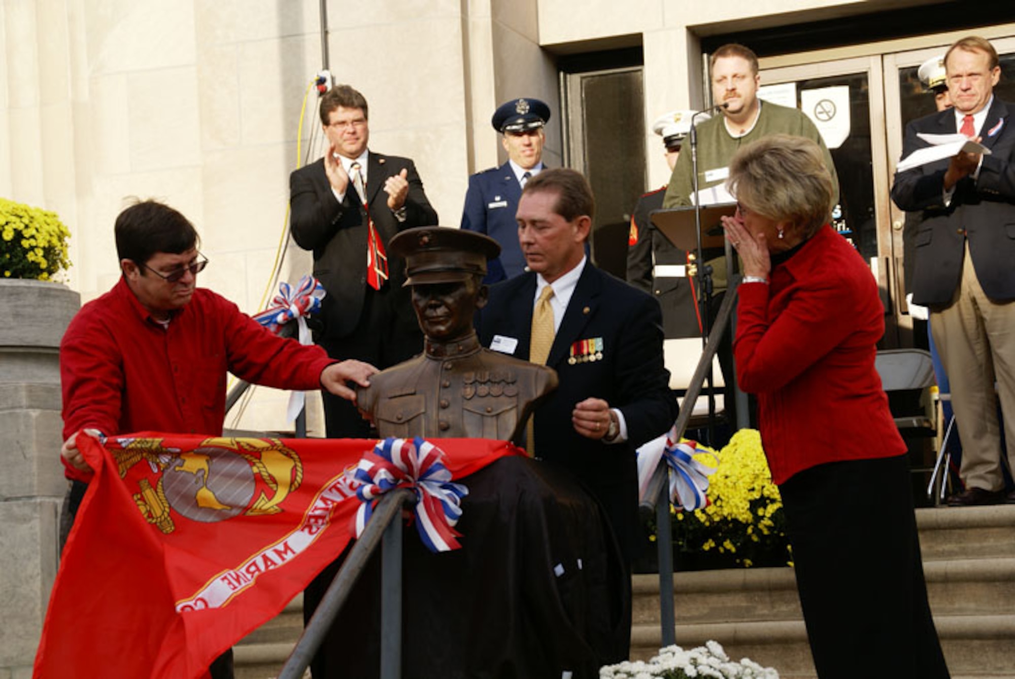 Aerospace Testing Alliance employee David Clemons unveils the bronze bust of his son Private First Class Nathan Clemons with the help of his wife Linda and Dave Uselton of Operation Never Forget at the memorial service Nov. 11 at the Franklin County Courthouse. (Photo by Philip Lorenz III)