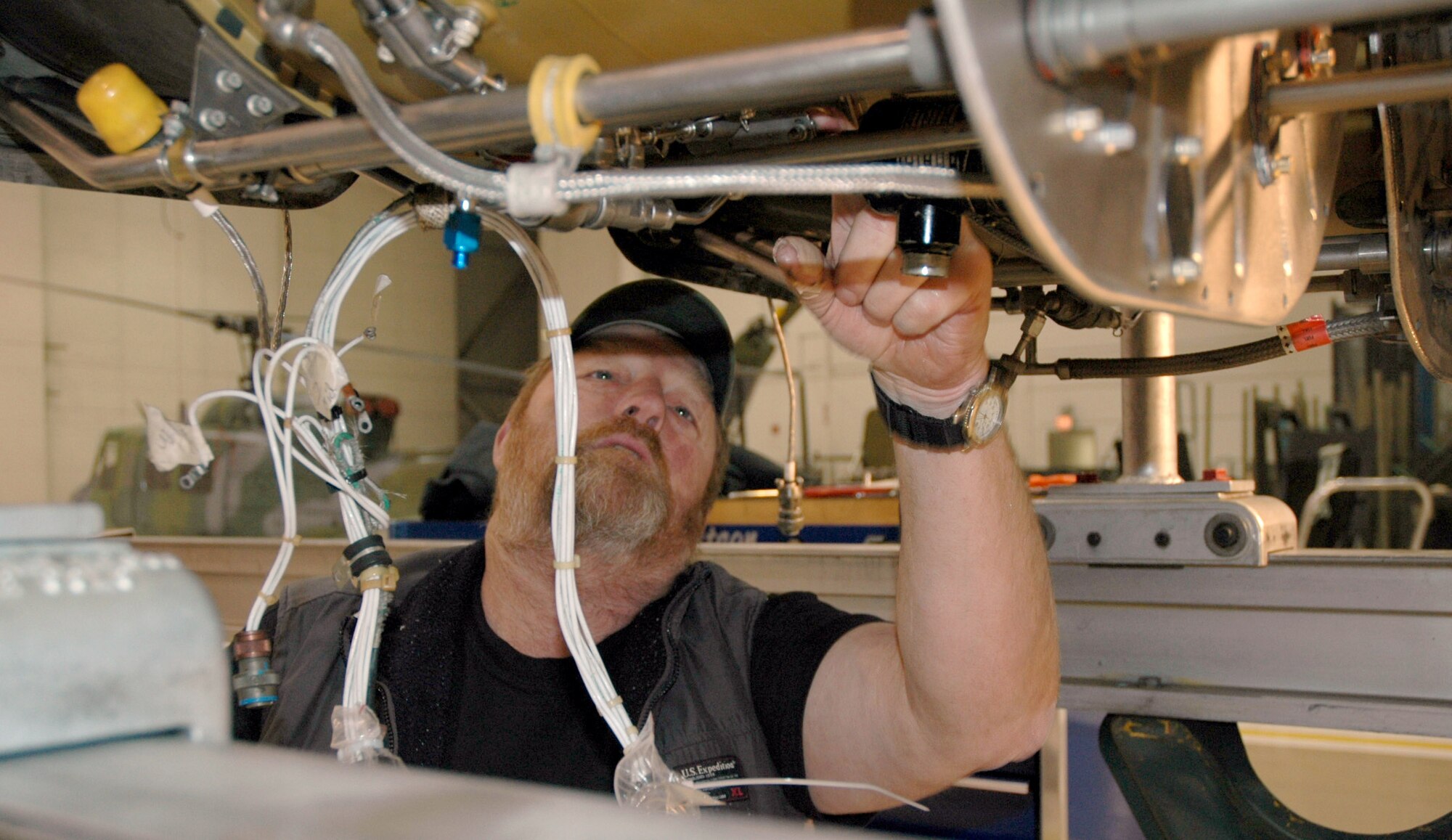Bill Wood, civilian maintenance contractor at the 40th Helicopter Squadron, works on a UH-1N Huey helicopter engine at Malmstrom Air Force Base, Mont., Oct. 31. Mr. Wood is one of 16 civilian contractors who work flightline and phase dock maintenance here. (U.S. Air Force photo/Senior Airman Eydie Sakura)