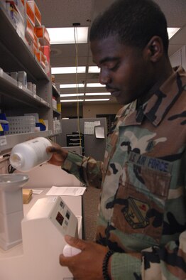 EIELSON AIR FORCE BASE, Alaska -- Staff Sgt. Thuduras Piert, 354th Medical Support Squadron pharmacy technician, puts pills into a Kirby Lester, a machine that counts pills at the medical clinic Nov. 14. The 354th Medical Group provides outpatient managed healthcare for all active duty military members and TRICARE eligible beneficiaries living in the Eielson area. (U.S. Air Force photo by Airman 1st Class Christopher Griffin)