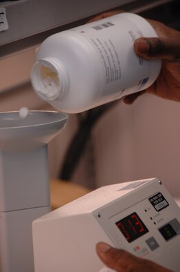 EIELSON AIR FORCE BASE, Alaska -- Staff Sgt. Thuduras Piert, 354th Medical Support Squadron pharmacy technician, puts pills into a Kirby Lester, a machine that counts pills Nov. 14 at the medical clinic. The 354th Medical Group provides outpatient managed healthcare for all active-duty military members and TRICARE eligible beneficiaries living in the Eielson area. (U.S. Air Force photo by Airman 1st Class Christopher Griffin)