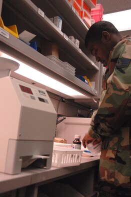 EIELSON AIR FORCE BASE, Alaska -- Staff Sgt. Thuduras Piert, 354th Medical Support Squadron pharmacy technician, places labels on medication for a prescribed patient at the medical clinic Nov. 14. The 354th Medical Group provides outpatient managed healthcare for all active duty military members and TRICARE eligible beneficiaries living in the Eielson area. (U.S. Air Force photo by Airman 1st Class Christopher Griffin)