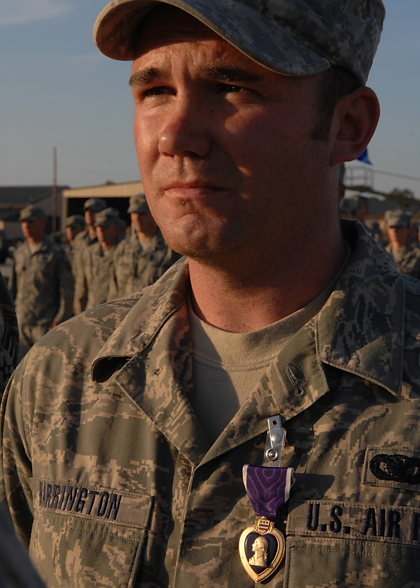 MOODY AIR FORCE BASE, Ga. -- Senior Airman Sean Harrington, 822nd Security Forces Squadron, receives the Purple Heart medal for wounds he suffered in combat during the unit's six-month deployment to Camp Bucca, Iraq.  Airman Harrington was one of three members of the 822nd SFS who received the Purple Heart during a redeployment ceremony here Nov. 14.  Staff Sgt. Chris Forsythe and Senior Airman Tyler Ginavan also received their medals at the ceremony.  A fourth member of the 822nd SFS, Staff Sgt. Rick Adams, was awarded the Purple Heart but was unable to attend the ceremony.  (U.S. Air Force photo by Airman First Class Brittany Barker)