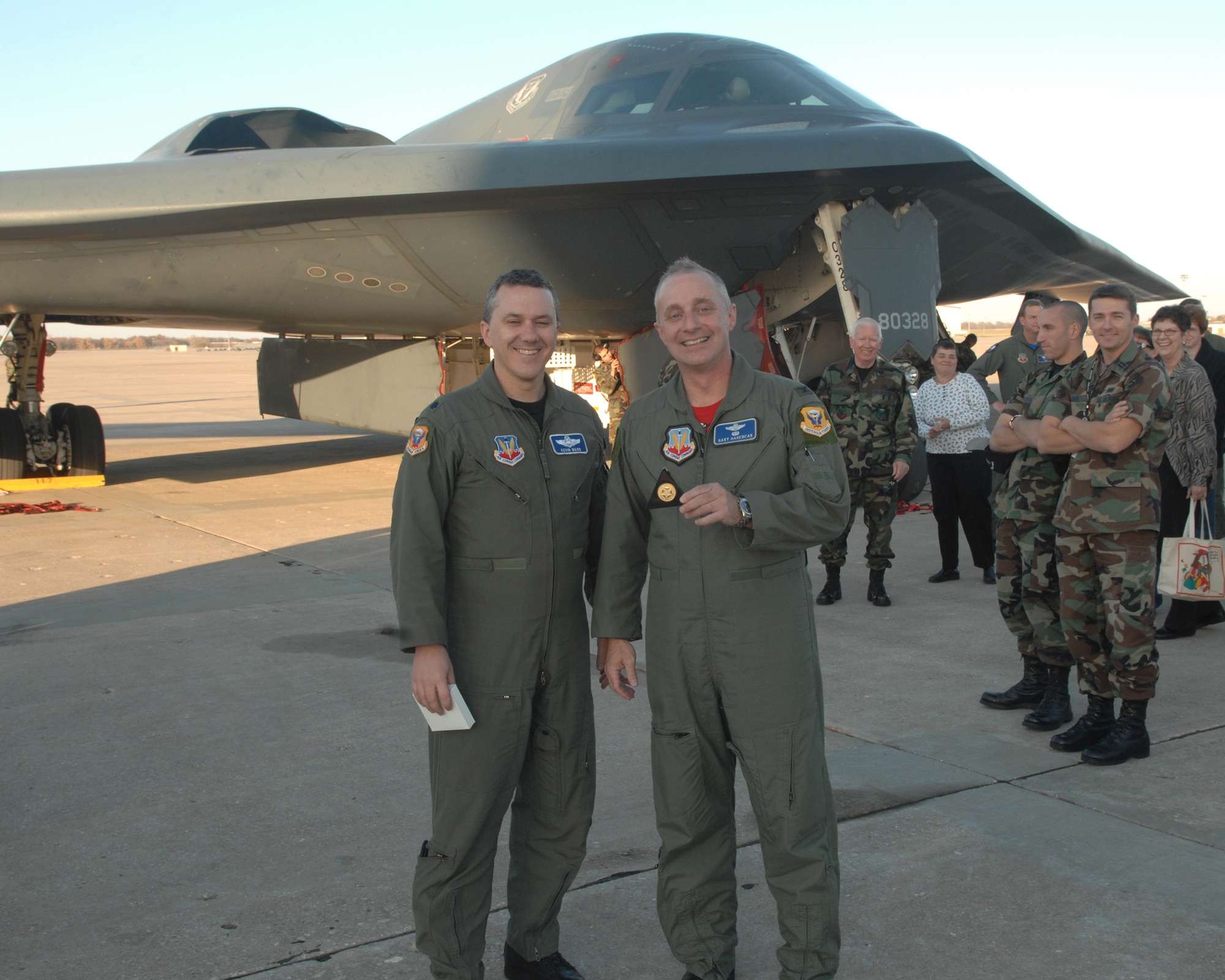 WHITEMAN AIR FORCE BASE, Mo. -- Lt. Col. Kevin Ward, 509th Bomb Wing director of staff and instructor pilot, congratulates Col. Garrett Harencak, 509th BW commander, as the commander holds up his Spirit coin for being the 407th person to fly a B-2. Colonel Harencak took his first B-2 flight in the Spirit of Texas Nov. 9. (U.S. Air Force photo/Airman 1st Class Cory Todd)