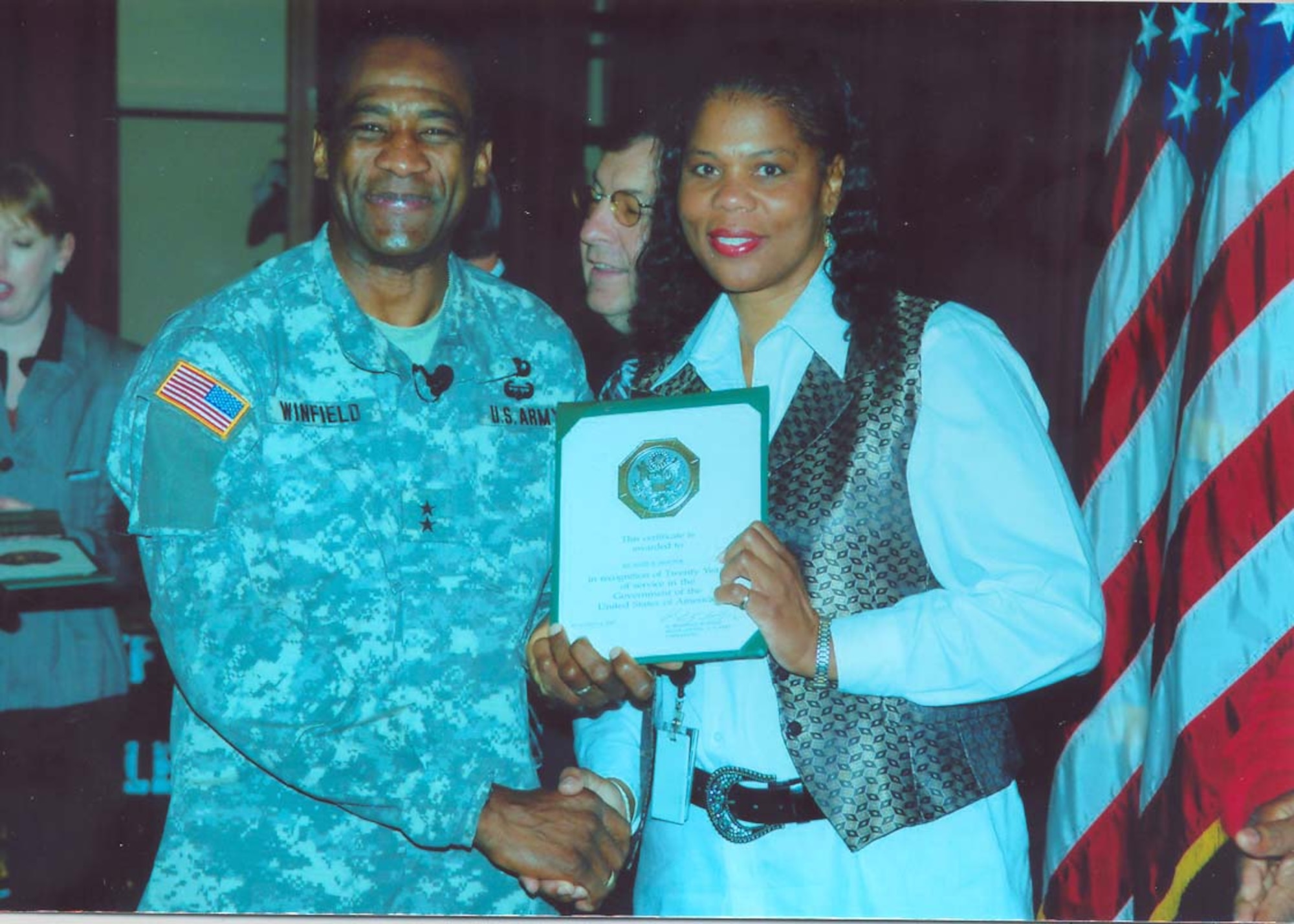 SEYMOUR JOHNSON AIR FORCE BASE, N.C. -- Master Sgt. Hazel Proctor (right), a reservist with the 916th Air Refueling Wing, is presented with her 20-year certificate for federal service. Presenting Sgt. Proctor her honor is Maj. Gen. Montague Winfield, commander for U.S. Army Cadet Command. Sgt. Proctor has worked with the ROTC program for the past 13 years as enlisted strength manager. As a reservist she serves with 916th Mission Support Flight as their first sergeant.