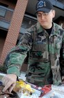 Senior Airman (SrA) Zachary Huston, 4th Communications Squadron, reaches for a snack on November 8, 2007 at Seymour Johnson AFB, North Carolina.  SrA Huston was volunteering to help with the Public Address System at the Chaplain's Dorm Office Grand Opening.  (US Air Force photo by Airman First Class Salma Din)(Released)