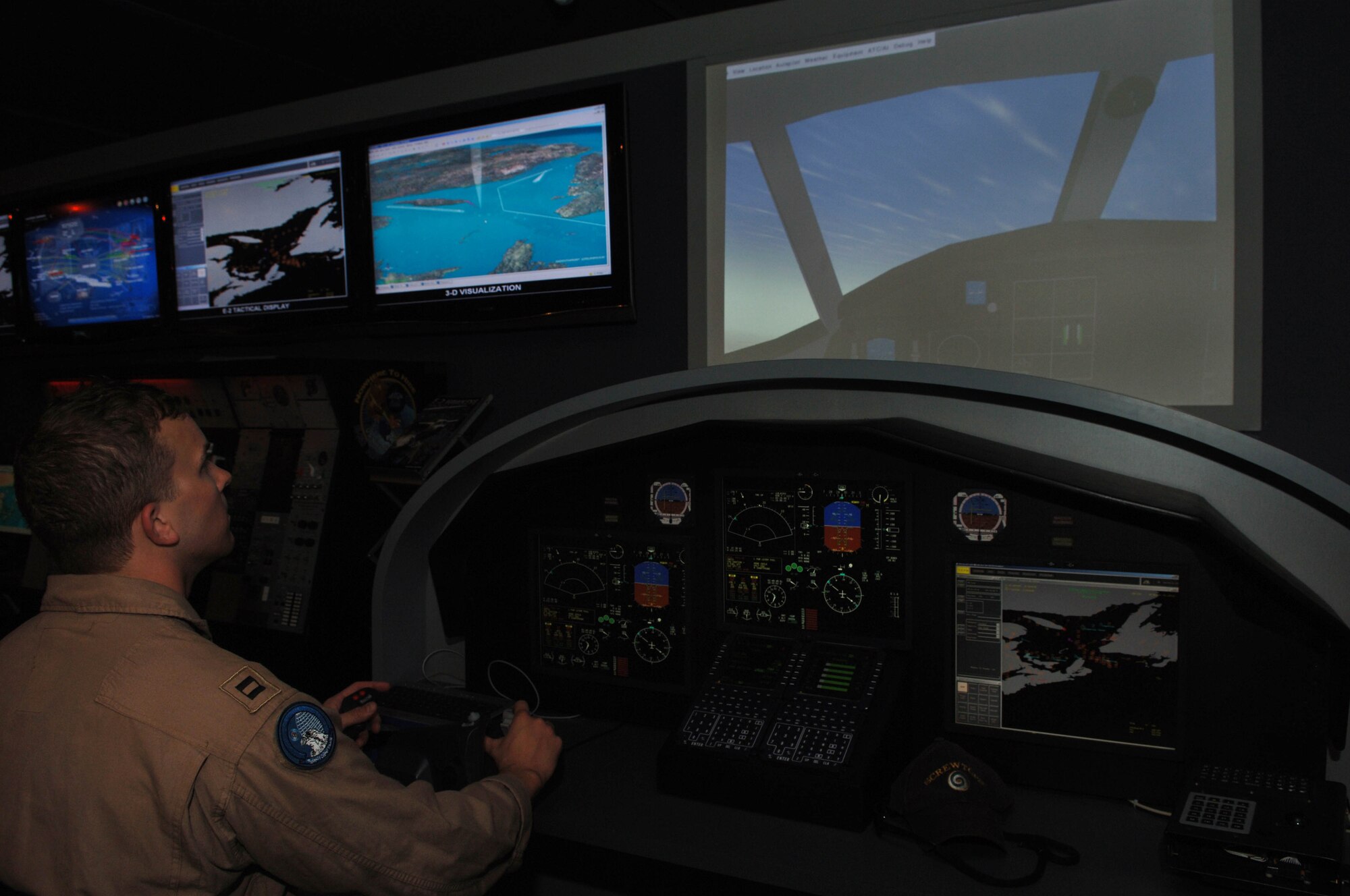 Lieutenant J.D. Wells with the VAW-123 from the USS Enterprise flies the Northrop Grumman E-2 Hawkeye flight simulator Nov. 12, 2007, during the Dubai Air Show. Lieutenant Wells is an aircrew member on the E-2 Hawkeye aircraft and is in the UAE in support of the air show. Approximately 250 Airman, Soldiers and Sailors, and various Air Force and Navy aircraft from bases in the Persian Gulf region and  the United States are supporting the air show from Nov 11-15 2007.  The U.S. Military has participated and provided support for Dubai's Air Show for many years.   (Air Force Photo by Tech. Sgt. Charlein C. Sheets)