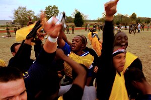 LANGLEY AIR FORCE BASE, Va. -- Brandon Davis (center) leads the 1st Communications Squadron in a chant after their victory over the 1st Aircraft Maintenance Squadron in Langley's intramural flag football championship game Nov. 13.  The 1st CS won, 19-13, with a touchdown by Rich Riddle with 13 seconds remaining in the game.  (U.S. Air Force photo/Staff Sgt. Samuel Rogers)