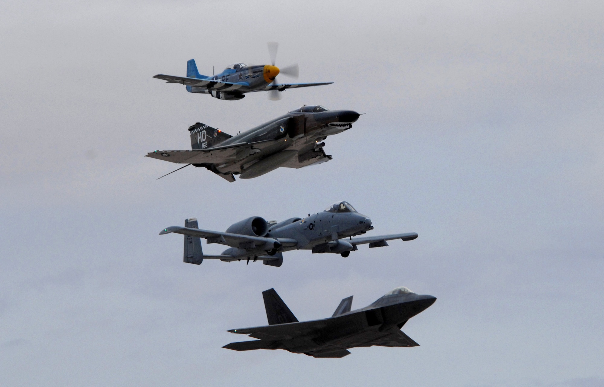 A P-51 Mustang, F-4 Phantom, A-10 Thunderbolt II and an F-22 Raptor perform the Heritage Flight during the closing of the Aviation Nation Air Show Nov. 11 at Nellis Air Force Base, Nev. Aviation Nation is one of the largest air shows in North America. This year's show commemorated 60 years of airpower and was the capstone event of the Air Force's yearlong 60th anniversary celebration. (U.S. Air Force photo/Staff Sgt. Taylor Worley)
