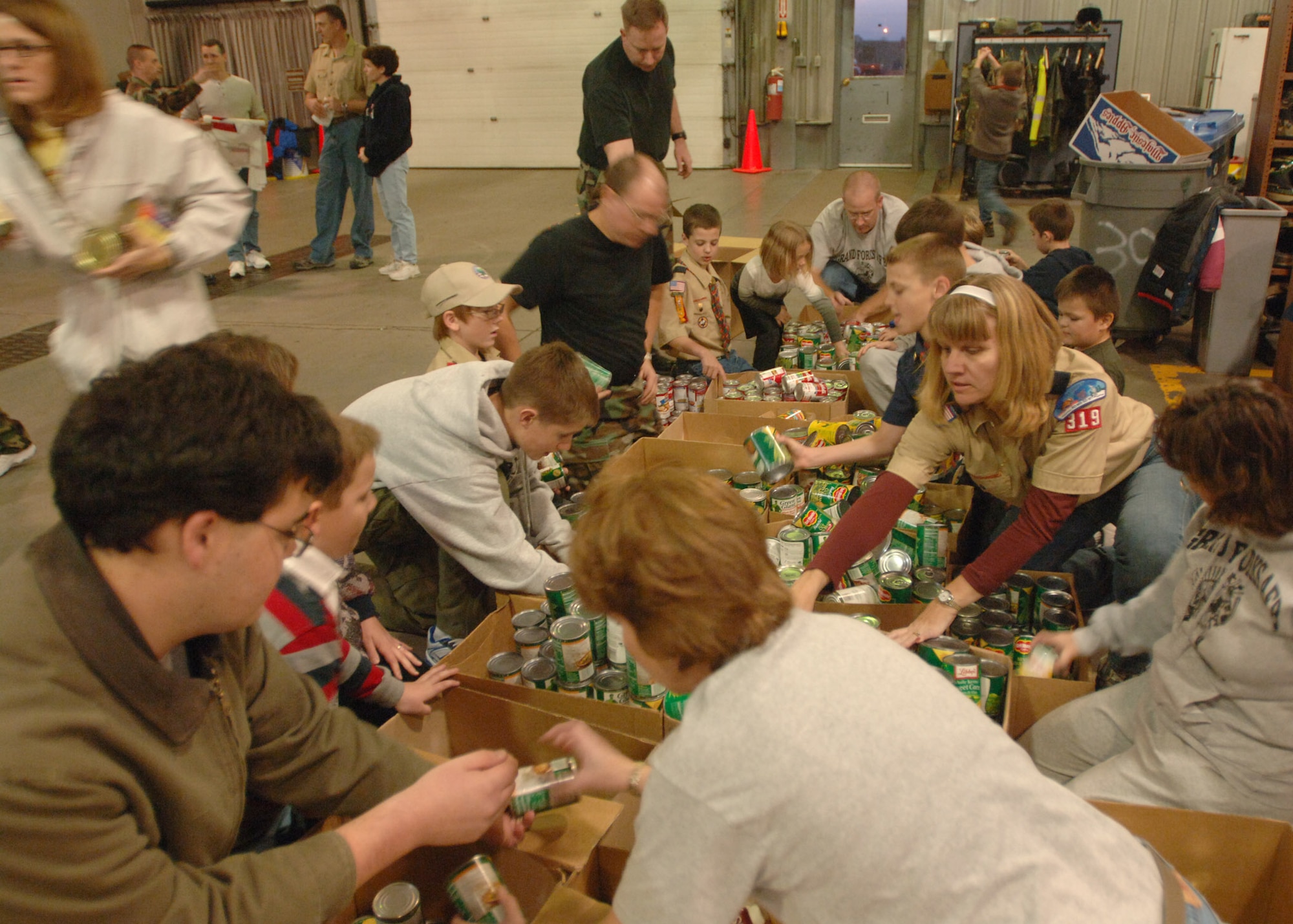 Scouting volunteers sort out canned goods and other non perishable items during Operation Warm Heart here Nov. 13. The Boy Scouts, Cub Scouts, Girl Scouts and first sergeants helped sort  thousands of canned goods and assembled 125 bagged meals during the event. (U.S. Air Force photo/Senior Airman Chad Kellum)    

 
