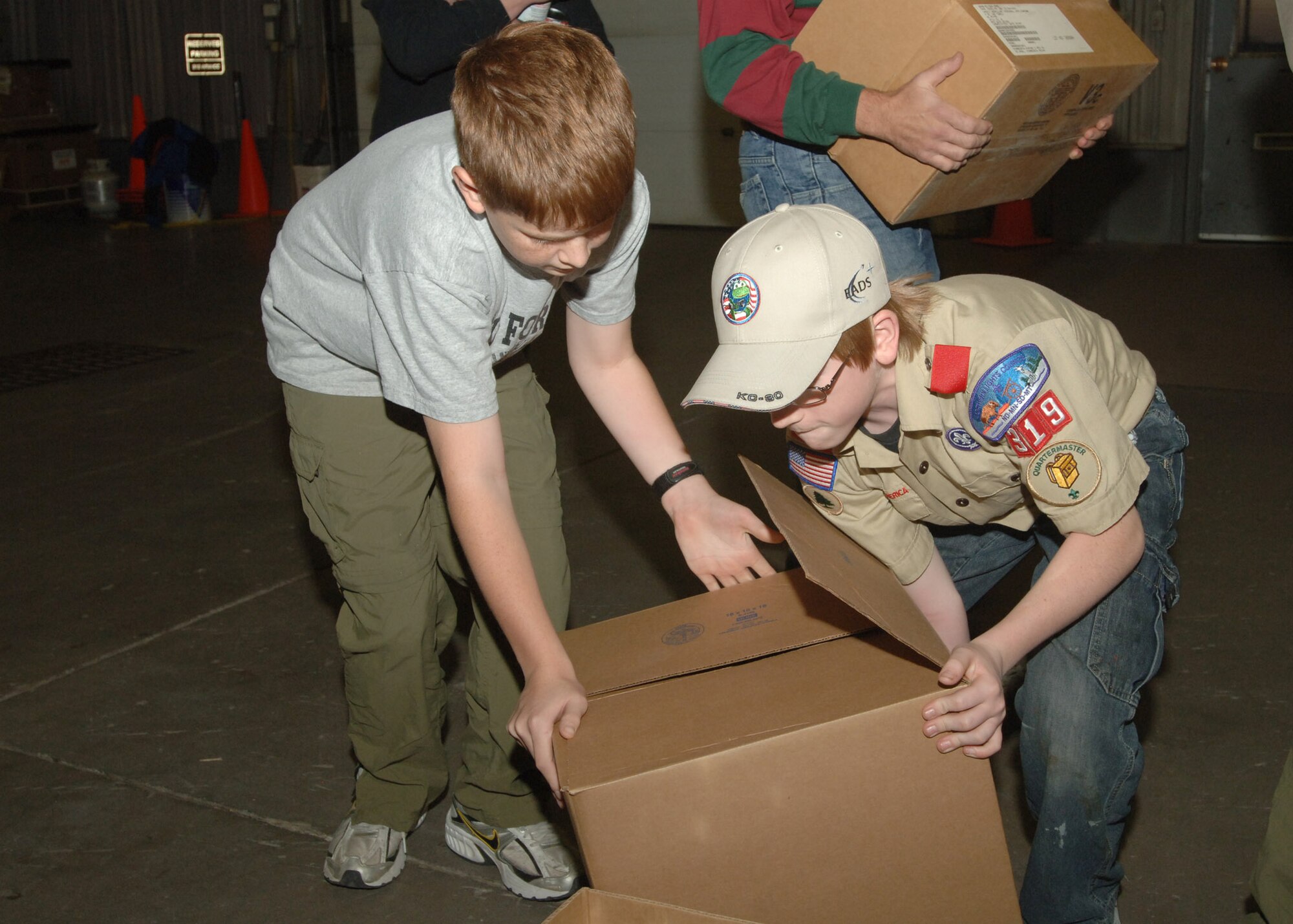 Ryan Ewers (left) and Nicholas Alvar from Boy Scout Troop 319 move a box of canned goods donated to base families during Operation Warm Heart here Nov. 13. The Boy Scouts, Cub Scouts, Girl Scouts and first sergeants helped sort  thousands of canned goods and assembled 125 bagged meals during the event. (U.S. Air Force photo/Senior Airman Chad Kellum)     

 
