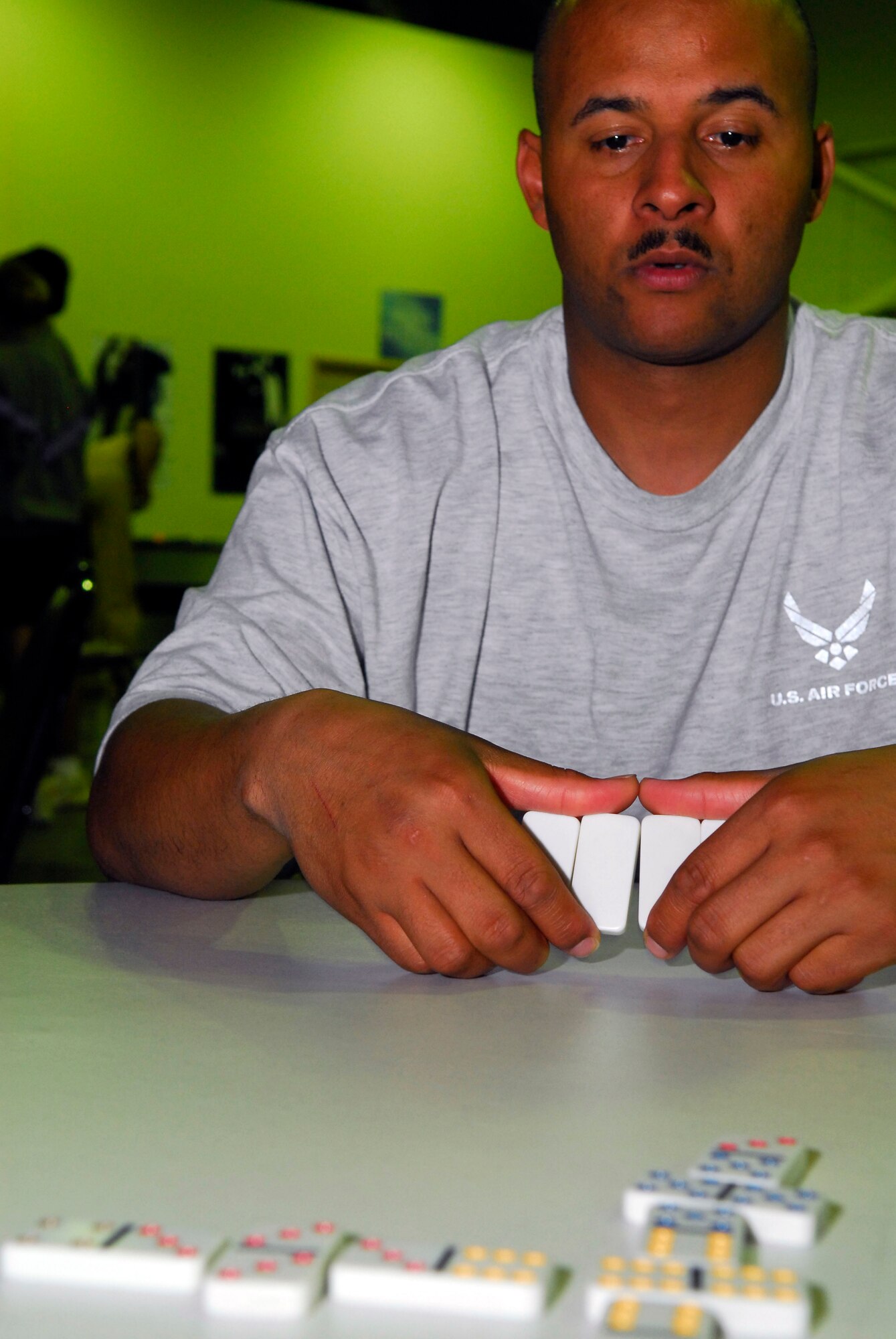 BALAD AIR BASE, Iraq -- Tech. Sgt. Eddie Keyes, 332nd Expeditionary Civil Engineering Squadron, contemplates what to play next during a game of dominoes at the Air Force recreation center here, Nov. 14. The center offers a variety of options to help servicemembers unwind. Sergeant Keyes is deployed from Yokota Air Base, Japan. (U.S. Air Force photo/Staff Sgt. Joshua Garcia)