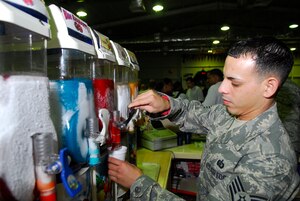 BALAD AIR BASE, Iraq -- Staff Sgt. Juan Ortiz, 332nd Expeditionary Services Squadron Recreational Center Assistant, pours a slushy for a customer. The recreational center offers personnel stationed here a place to relax and get away from the bustle of the mission. Sergeant Ortiz is deployed from Langley Air Force Base, Va. (U.S. Air Force photo/Staff Sgt. Joshua Garcia)