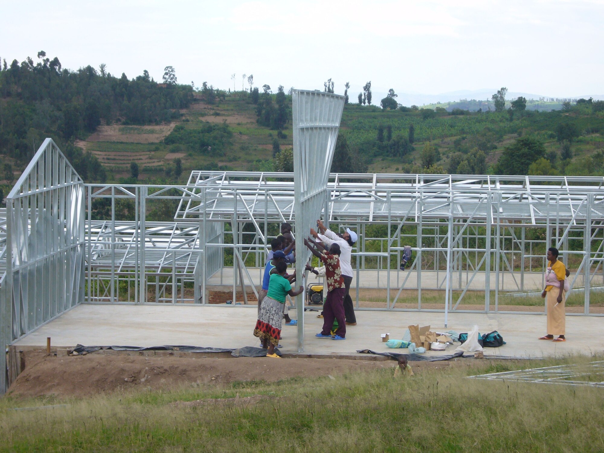 Local Rwandan construction workers raise a wall to a classroom on the Shyara School. The school will accomodate 300 male and female students. when it is completed in late November of 2007.  (U.S. Photo by Capt. Erin Dorrance)
