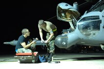 Senior Airman John Baia and Airman 1st Class Eric Dininger, 23rd
Equipment Maintenance Squadron, work on an HH-60G Pave Hawk helicopter Oct. 31 at Moody Air Force Base, Ga. Moody Airmen work around the clock to ensure
flight success of the aircraft. (U.S. Air Force photo by Senior Airman
Elizabeth Rissmiller) 
