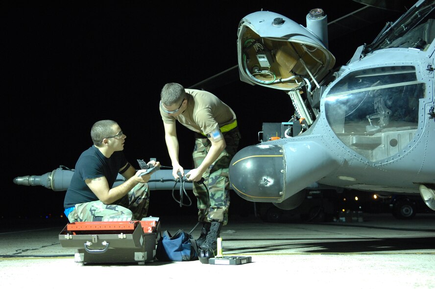 Senior Airman John Baia and Airman 1st Class Eric Dininger, 23rd
Equipment Maintenance Squadron, work on an HH-60G Pave Hawk helicopter Oct. 31 at Moody Air Force Base, Ga. Moody Airmen work around the clock to ensure
flight success of the aircraft. (U.S. Air Force photo by Senior Airman
Elizabeth Rissmiller) 
