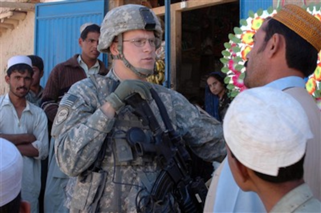 U.S. Army Staff Sgt. Kevin Rathbun talks with a local villager in Padhvab Shaneh, Afghanistan, on Oct 31, 2007. Rathbun is attached to the Military Police Platoon, Headquarters and Headquarters Company, 4th Brigade Special Troops Battalion, 82nd Airborne Division.  