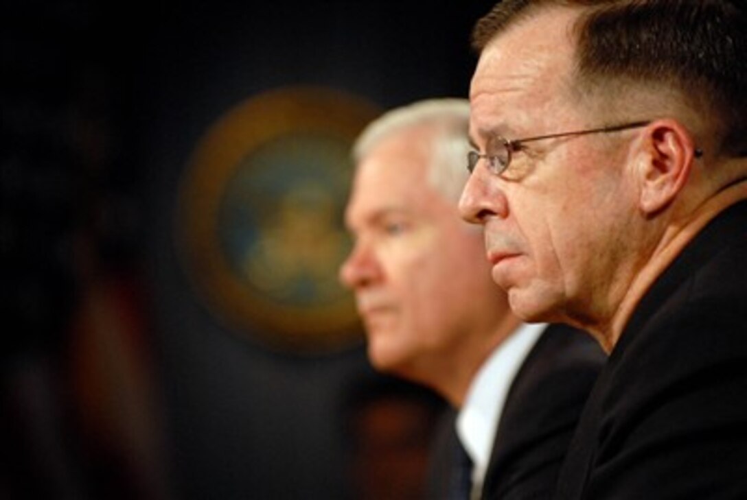 Secretary of Defense Robert M. Gates (left) and Chairman of the Joint Chiefs of Staff Adm. Mike Mullen, U.S. Navy, listen to a reporter's question as they conduct a media roundtable in the Pentagon on Nov. 15, 2007.  