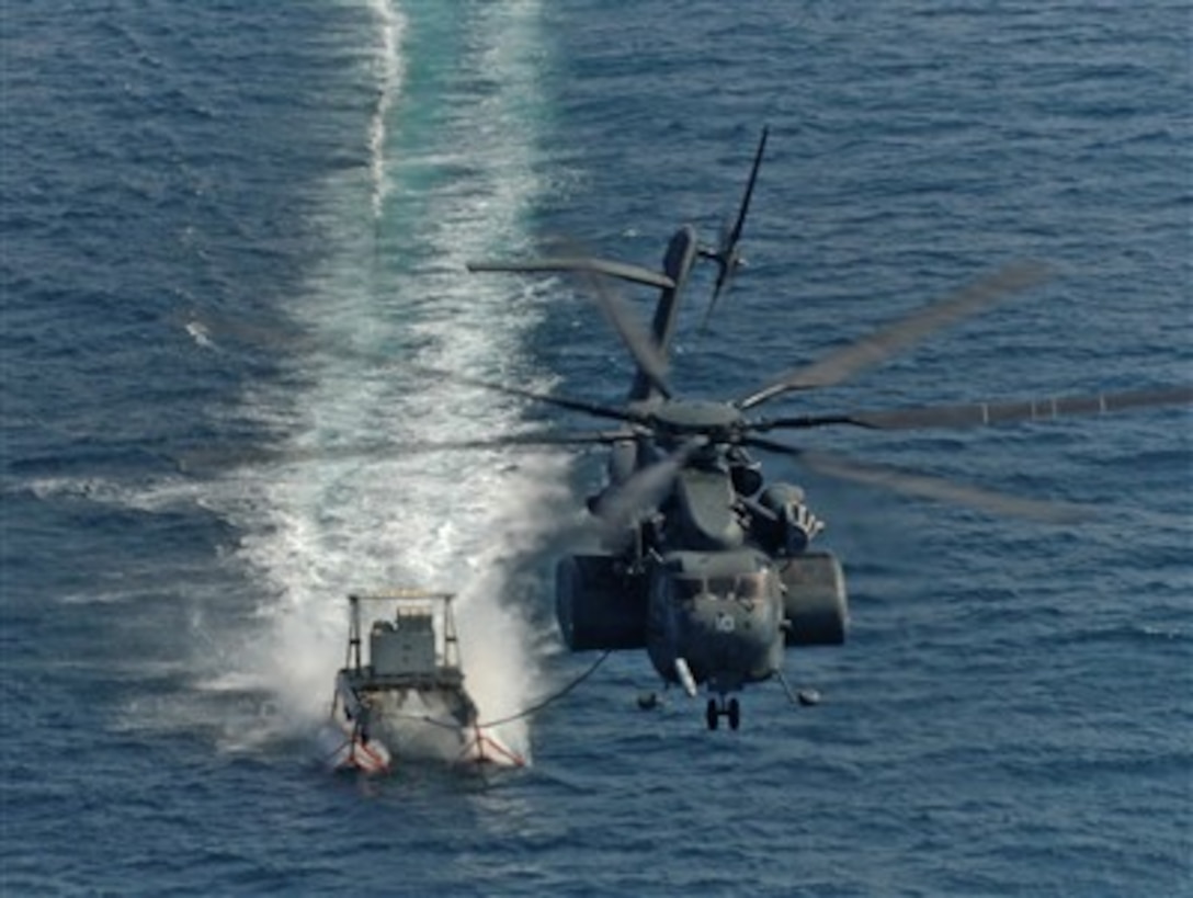 A U.S. Navy MH-53E Sea Dragon helicopter pulls an MK-105 minesweeping sled during mine countermeasure training in the Persian Gulf on Nov. 12, 2007.  The helicopter is from Helicopter Mine Countermeasure Squadron 15 deployed aboard the multipurpose amphibious assault ship USS Wasp (LHD 1).  