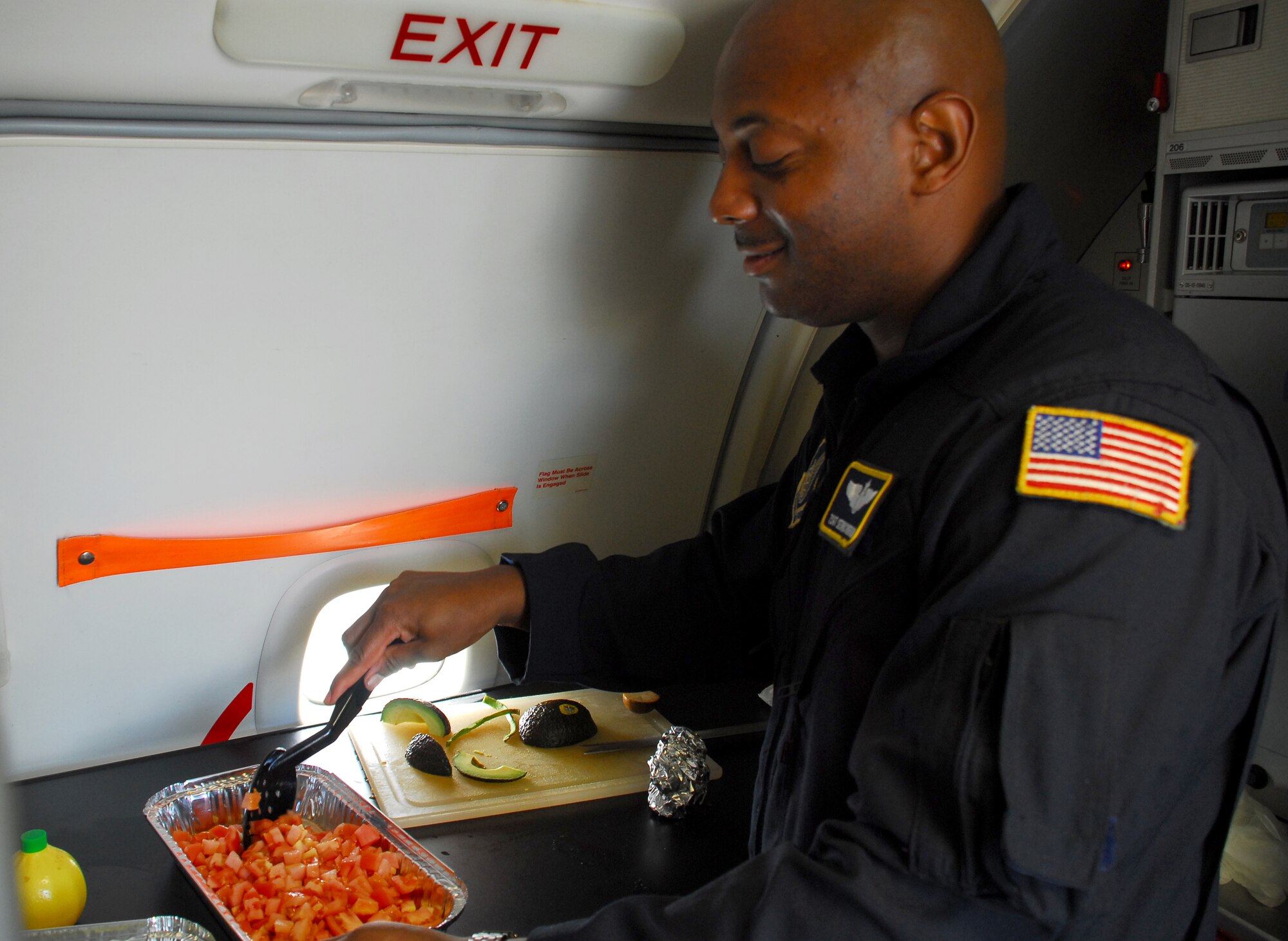 Tech. Sgt. Sedric Roberson, 65th Airlift Squadron flight attendant, prepares the meal for the spouse's flight. Photo by Staff Sgt. Erin Smith